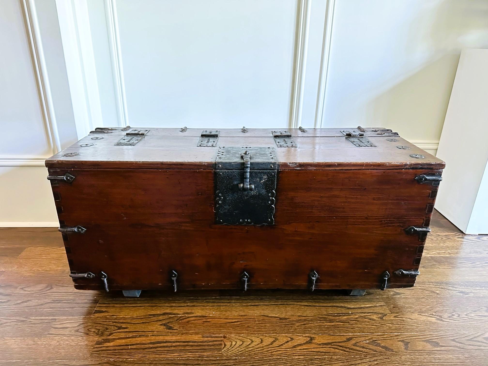 A large Korean top-lid chest on block feet circa 19th century of Joseon Dynasty. Known as coin chest (Ton-Kwe in Korean), this type of chest was originally used for storing money. The larger versions were probably used to store other valuables. They