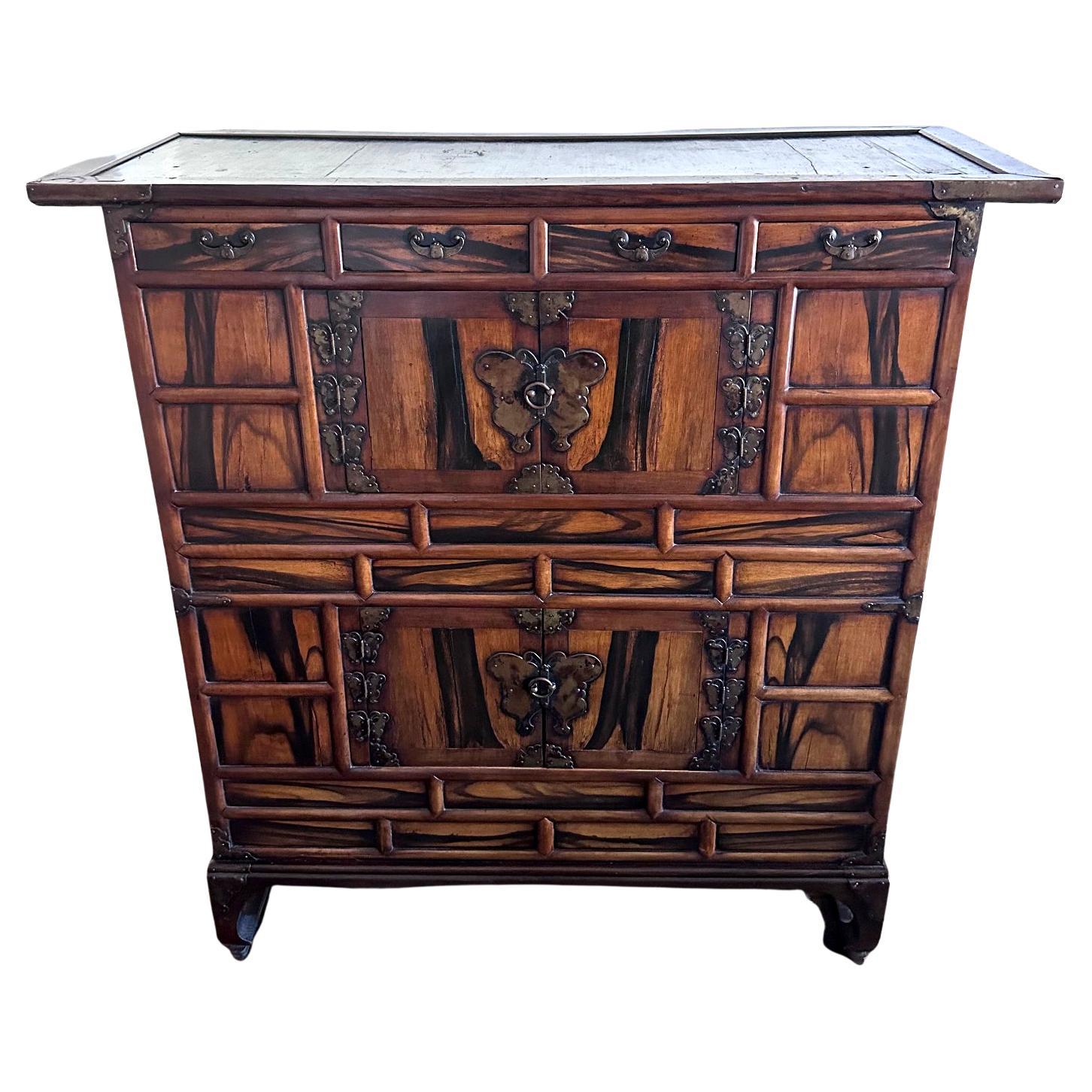 Known as Ich'ung Jang in Korean, this large chest features a double-level storage space chests with frontal open doors on a gridded facade. Constructed from pine and zelkova (Korean elm wood) in frame, the chest showcases a beautiful facade with