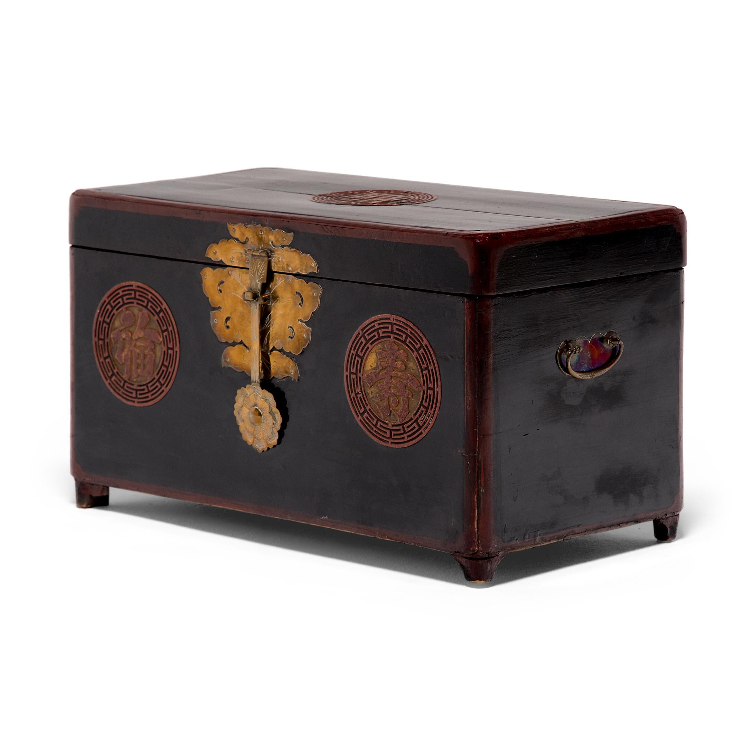 Dated to the early 20th century, this lacquered Korean wedding chest is decorated with round medallions conveying three blessings for a good life. Enclosed by lattice-like fret patterns, the medallions offer blessings of luck (?), longevity (?), and