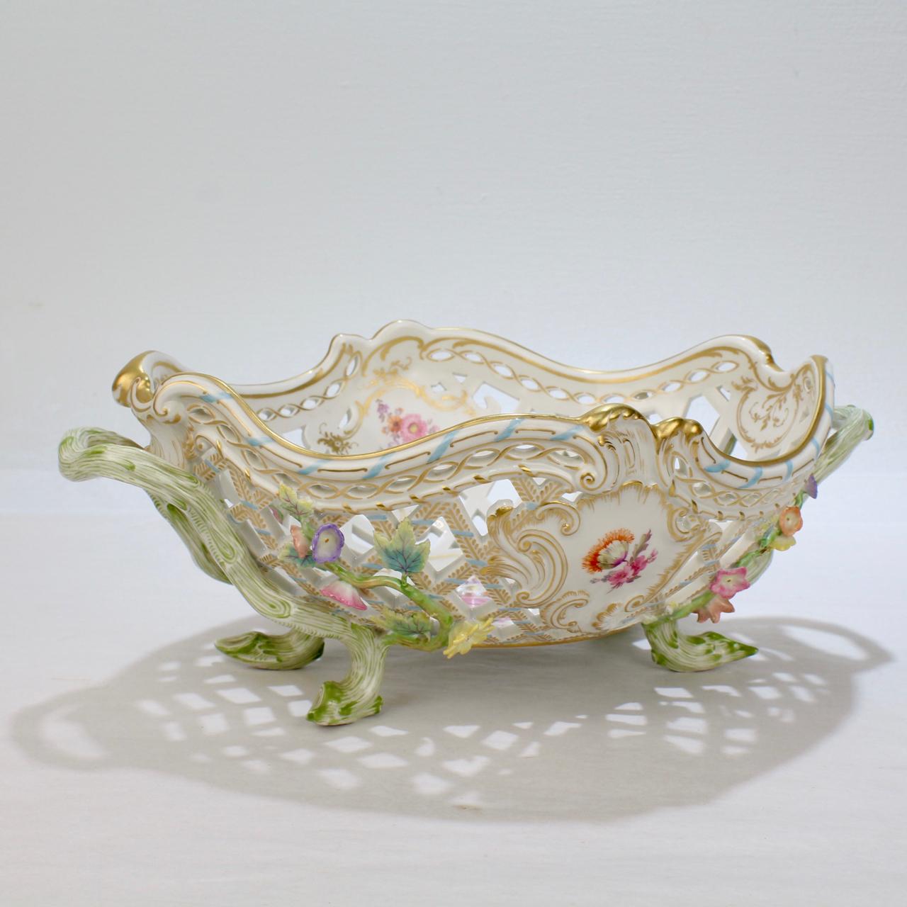 A very fine, antique KPM porcelain flower encrusted fruit basket.

With traditional twig form handles and feet, an openwork body, flower encrustation, and hand painted floral decoration throughout. 

Marked to the base with a blue underglaze