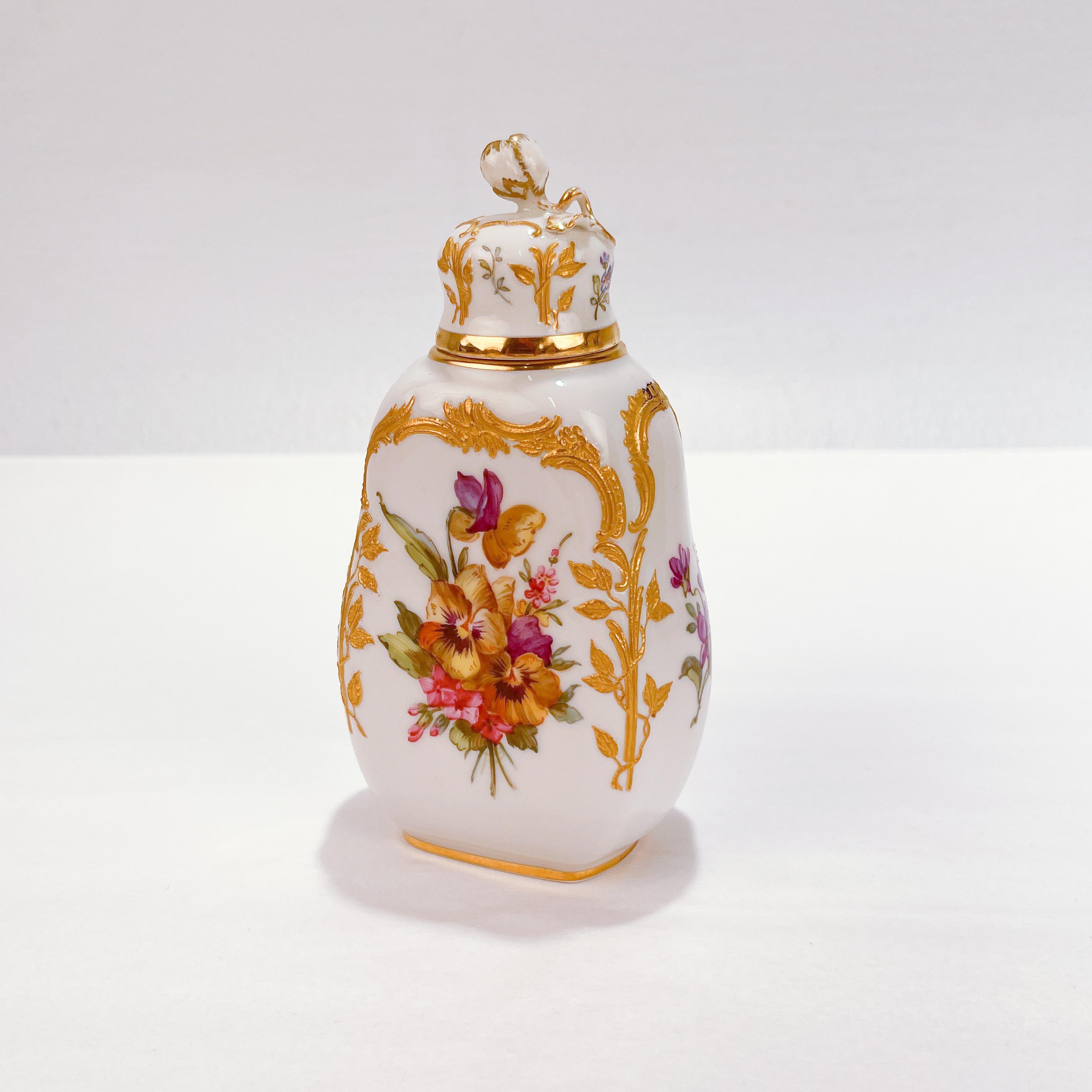 An exceptional KPM Neuzierat porcelain tea caddy or dresser bottle.

With floral decoration and elaborate gilt leaf and vine designs and rocailles.

The lid has a flower bud finial.

Simply a top shelf piece of Royal Berlin KPM