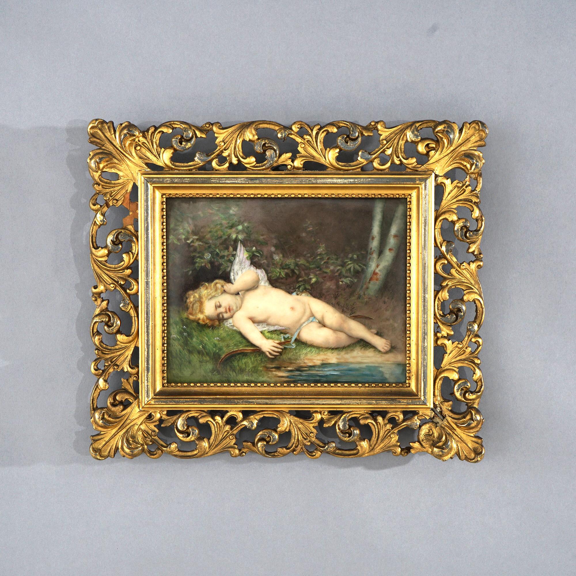 An antique painting on porcelain in the manner of KPM depicts Cupid reclining on creek shore seated in foliate form giltwood frame, 19th century

Measure - 10.75