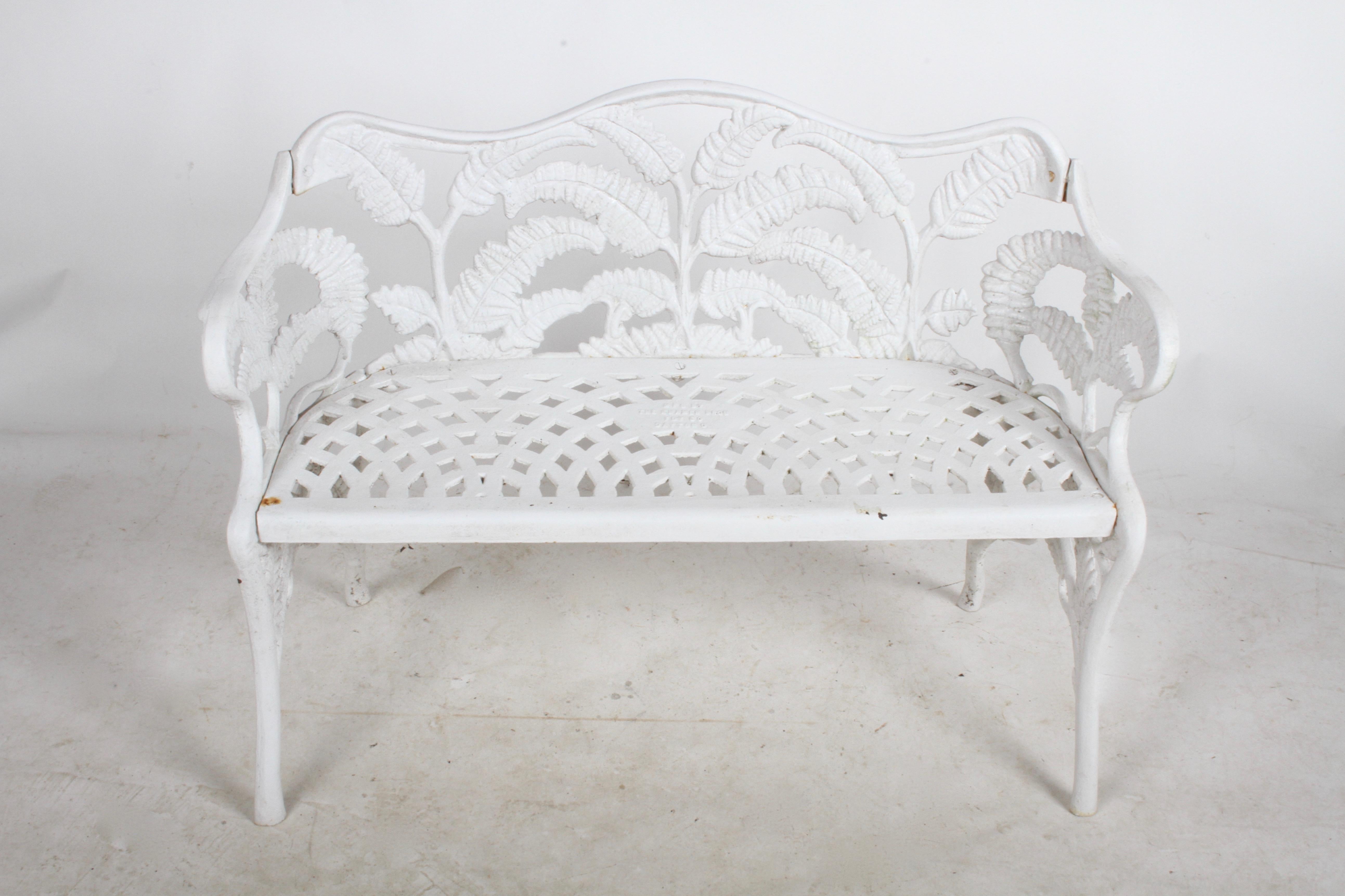 Kramer Brothers fern pattern cast iron bench with several older coats of white paint, some wear and light rust. Retains foundry stamp. Can be repainted, sand blasted, dipped in rust inhibitor for additional cost. Very heavy, well made cast iron