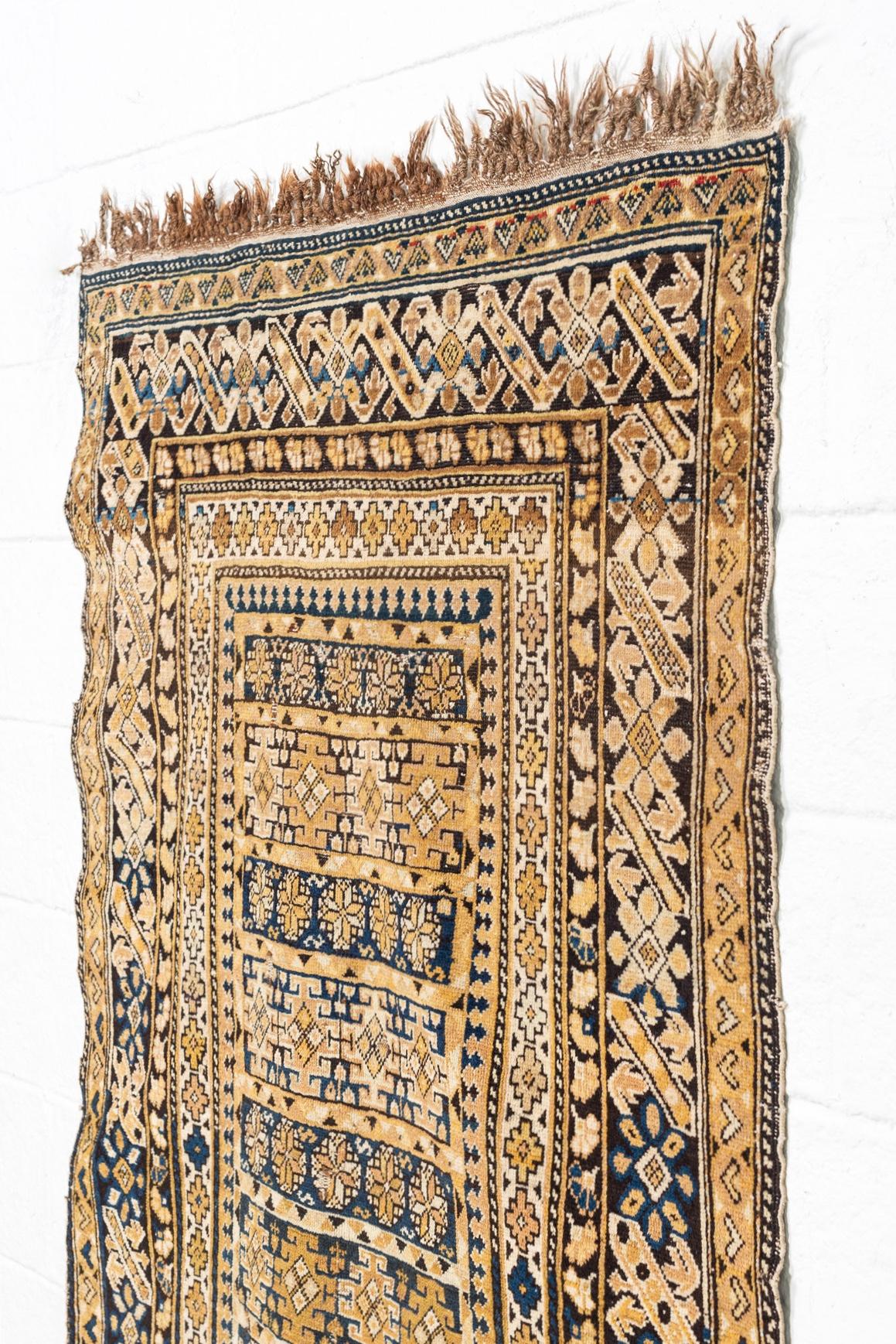 This exquisite antique handwoven Kuba rug circa late 1800s is from the Caucasus region (present-day Azerbaijan) and features a stunningly rich and intricate geometric pattern infused with tribal symbolism with beautiful depth of color in shades of