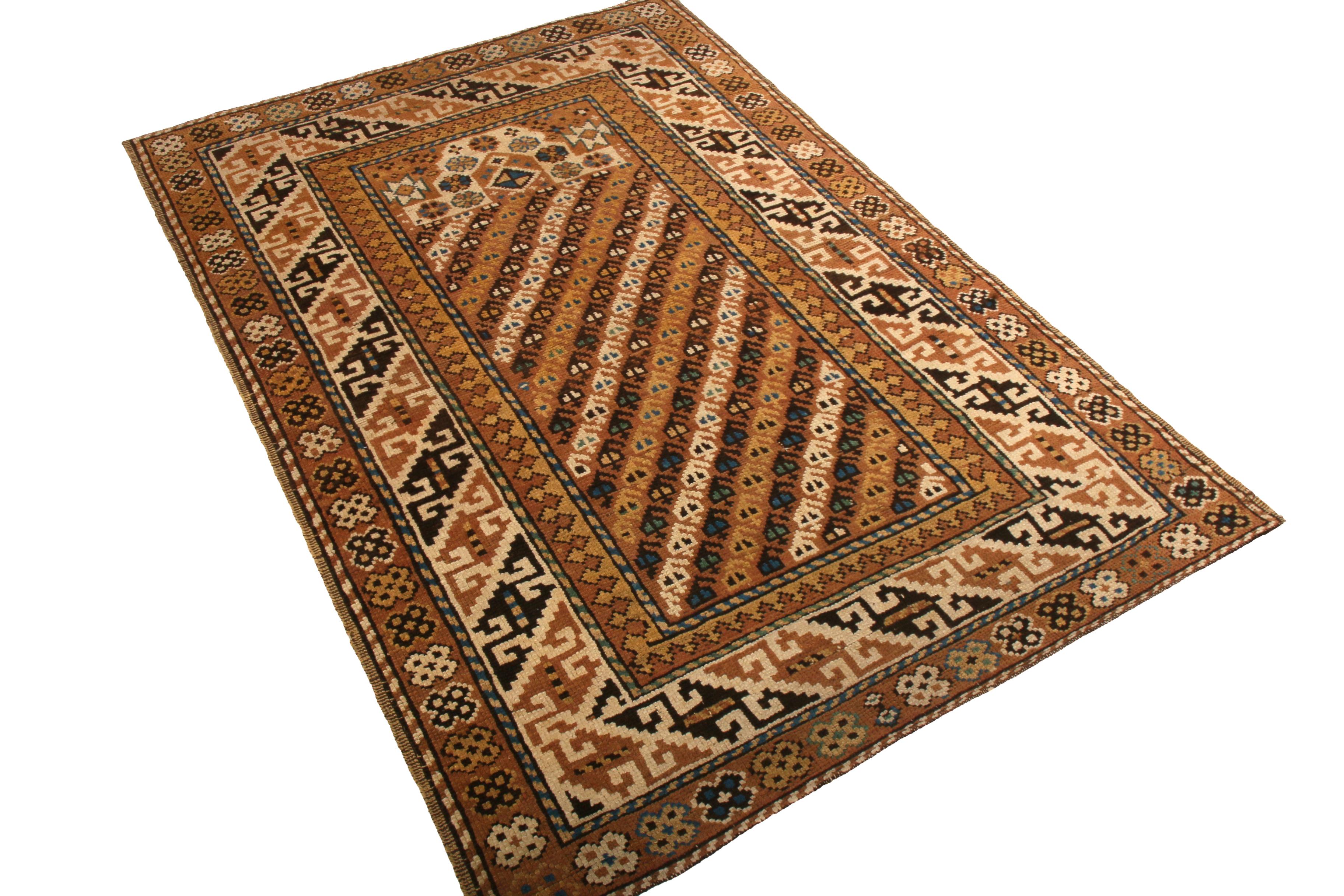 Made with hand knotted wool originating from Russia between 1890-1900, this antique Kuba rug depicts an impressive marriage of tribal geometry with lesser-employed radiant hues of beige-brown and golden-yellow, complementing the subtle juxtaposition