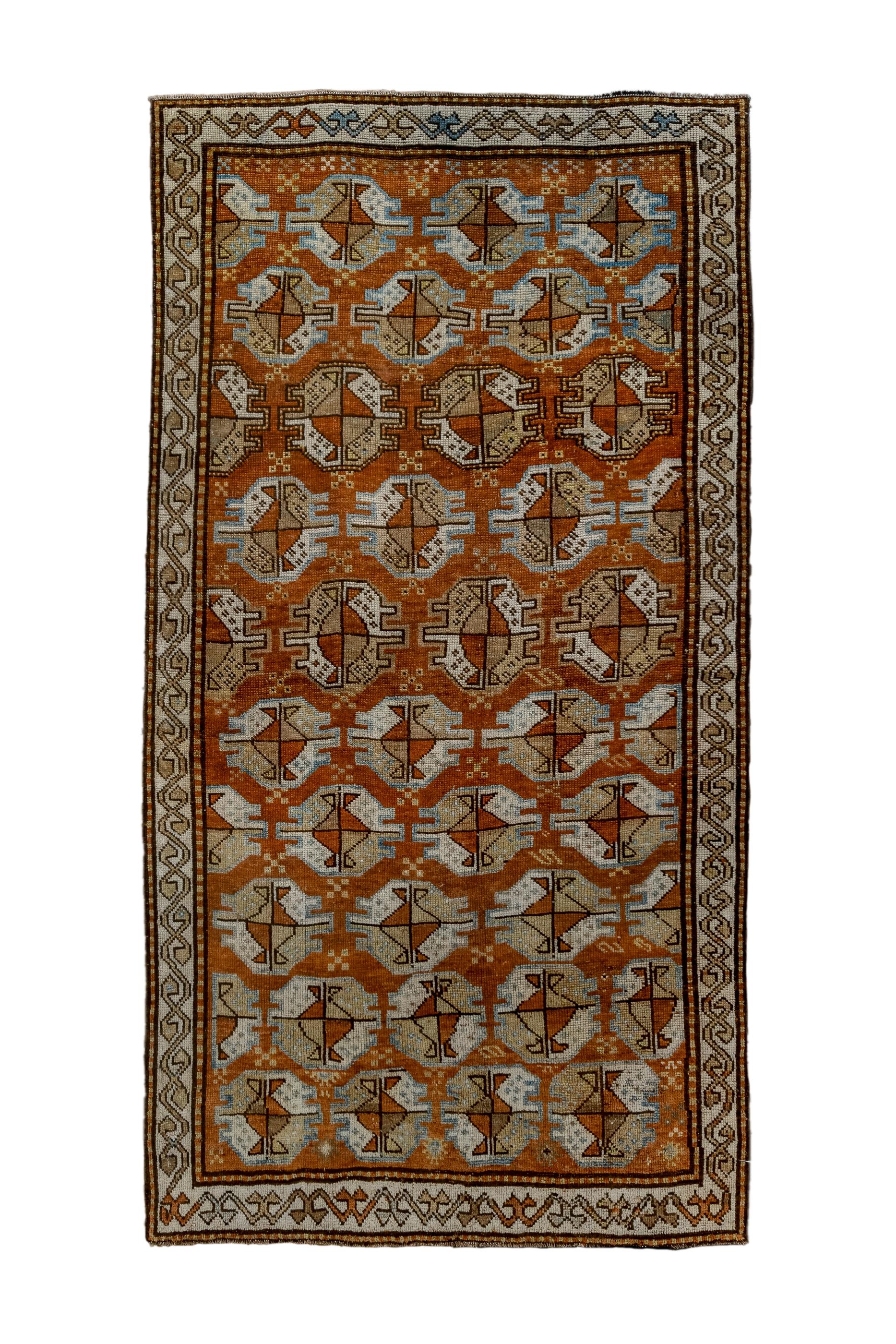 Kurds were settled in the early 17th century in Khorassan and they adopted certain Turkmen design elements, as here shown in this antique piece with ten offset rows of Tekke or Yomud guls on a red ground. The guls are quartered in ecru and