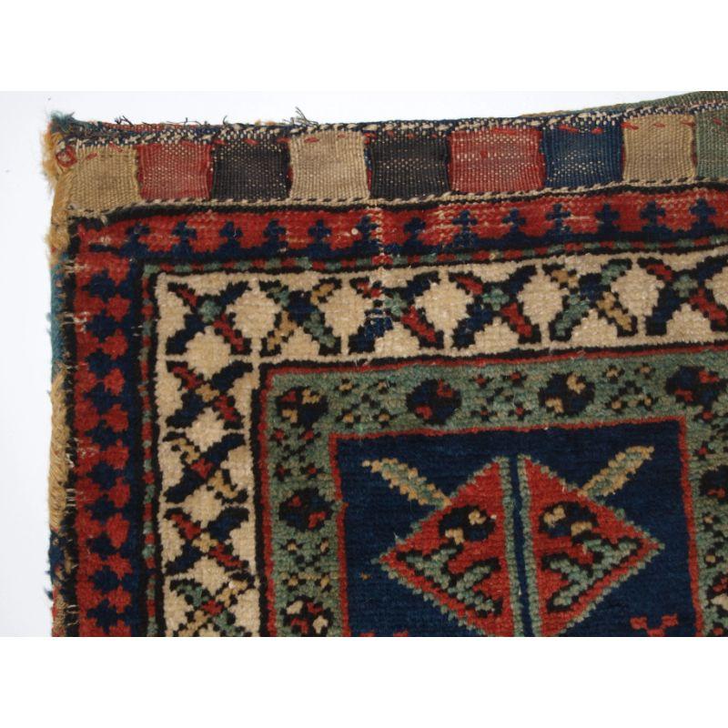 Antique Kurdish bag complete with stripped plain weave back.

The bag face is very well drawn with a simple design, surrounded by three borders

The bag is complete and has a good stripped plain weave back and nice closing lappets at the