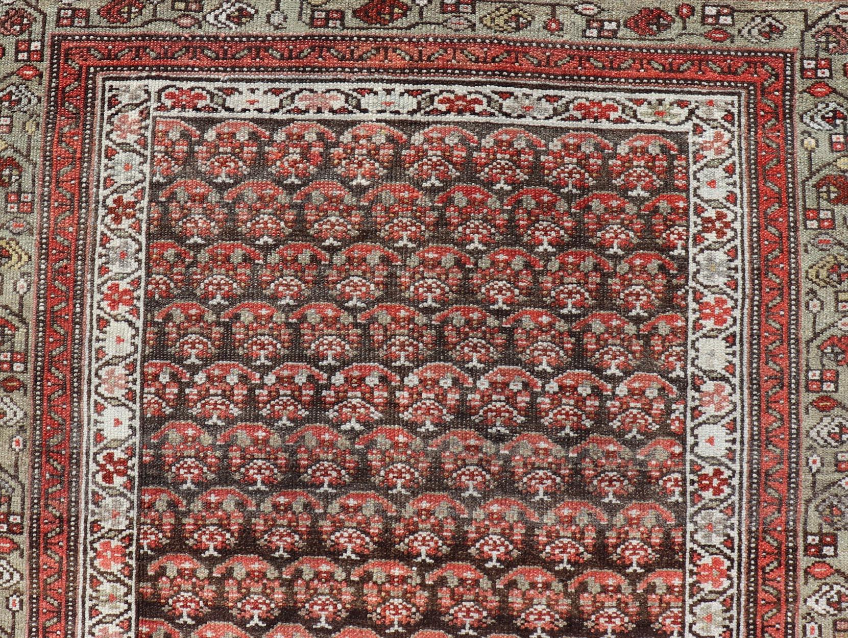 Antique Kurdish Gallery Runner with All-Over Paisley Design in Brown, Red, Green. Keivan Woven Arts / rug EMB-22230-15466, country of origin / type: Iran / Kurdish, circa 1920.
Measures: 4'3 x 10'1 
This Kurdish gallery runner from early 20th