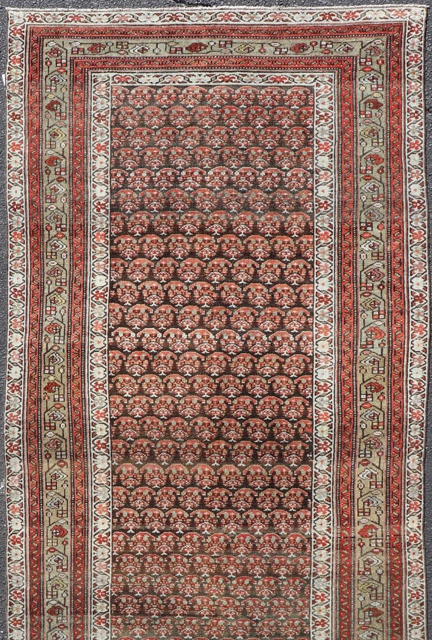 Persian Antique Kurdish Gallery Runner with All-Over Paisley Design in Brown, Red, Green For Sale