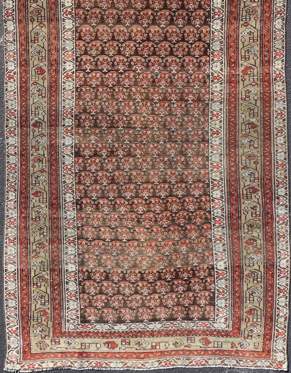 Antique Kurdish Gallery Runner with All-Over Paisley Design in Brown, Red, Green In Good Condition For Sale In Atlanta, GA