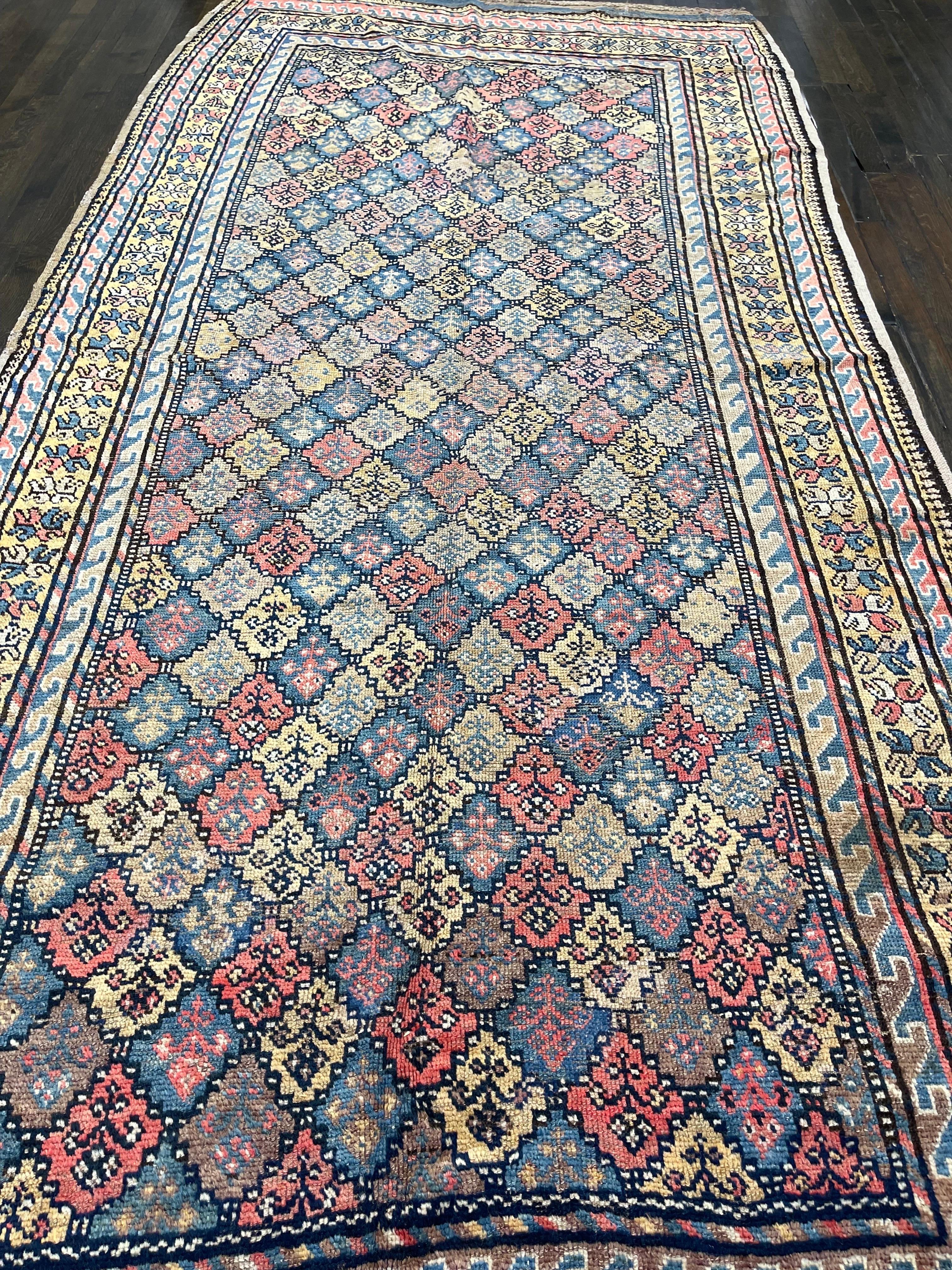 A well drowned Kurdish kazak corridor rug with brilliant colors of flowerheads that are highly abstract rosettes. 

The serrated outline of each ornament and colors in which each has been woven evoke petals, while the star filled diamond