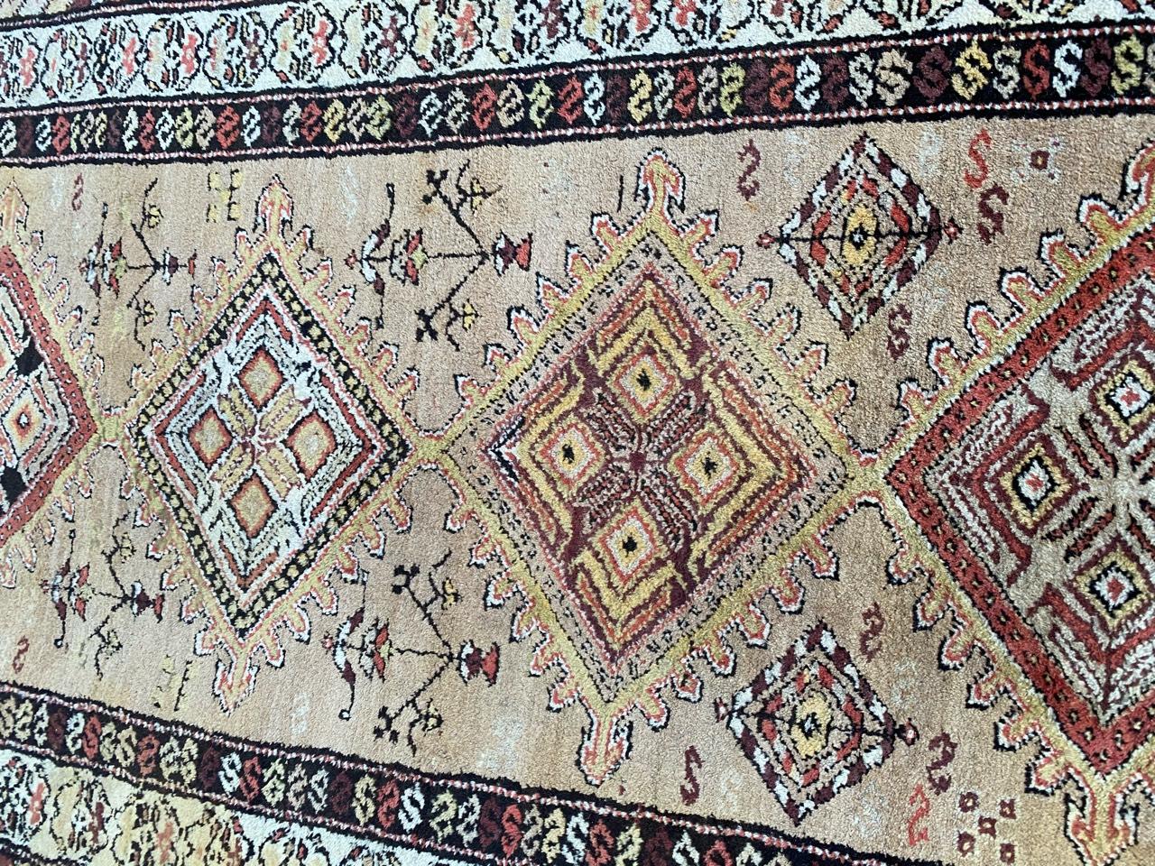 Beautiful early 20th century Kurdish rug with beautiful tribal and geometrical design and nice natural colors with cream, yellow, red and purple, entirely hand knotted with wool velvet on wool foundation.