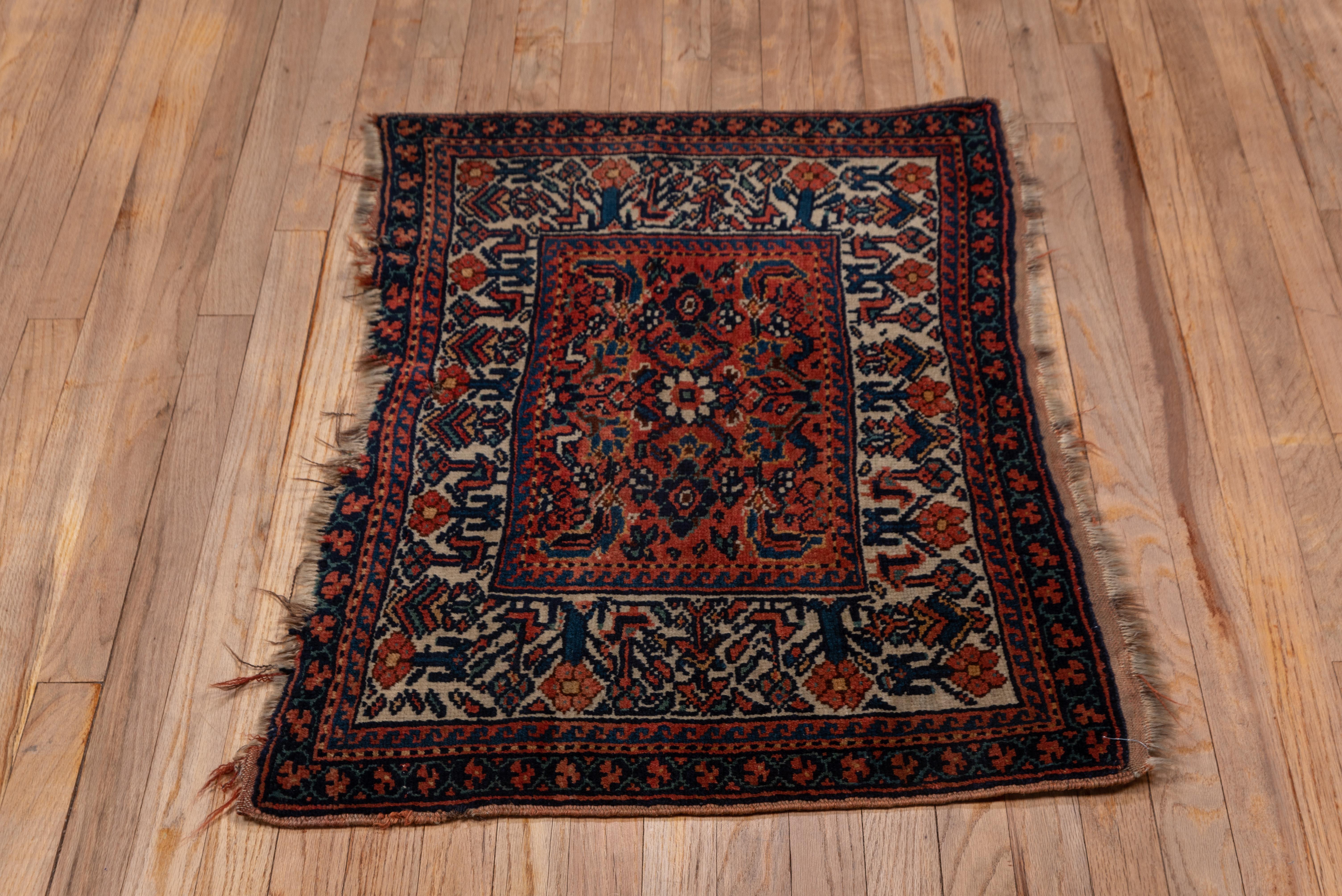 This west Persian tribal bagace shows a rusty red field centered on a rosette within a single Herati module. Ecru border with birds, flowers and palmettes. Outer border of flip-flop florets. Wool foundation, moderate rustic weave.