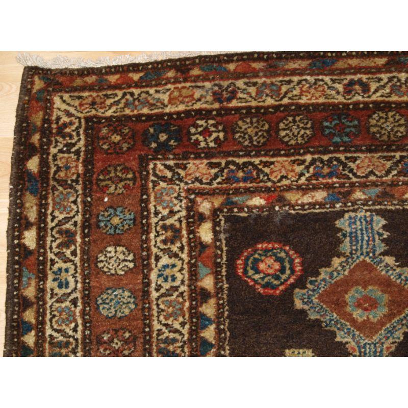 Antique Kurdish long rug with linked medallion design.

A charming old rug with a very gentle feel, the colours have a very harmonious feel.... a real country house rug.

The use of soft yellow in the border design is very pleasing.

Good