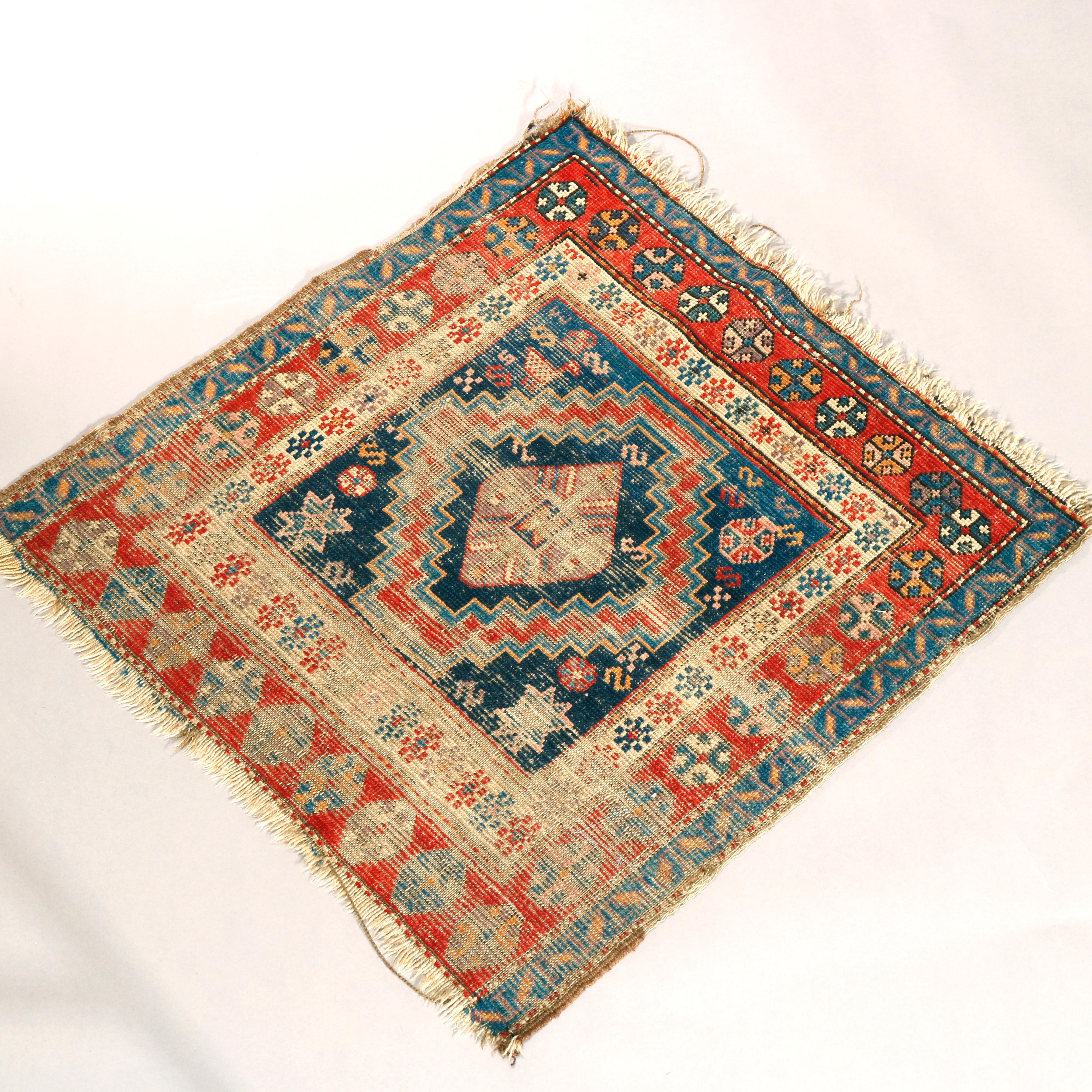 An antique Kurdish oriental mat offers wool construction having serrated geometric central medallion with geometric elements including stars on blue ground, circa 1890

Measures: 38