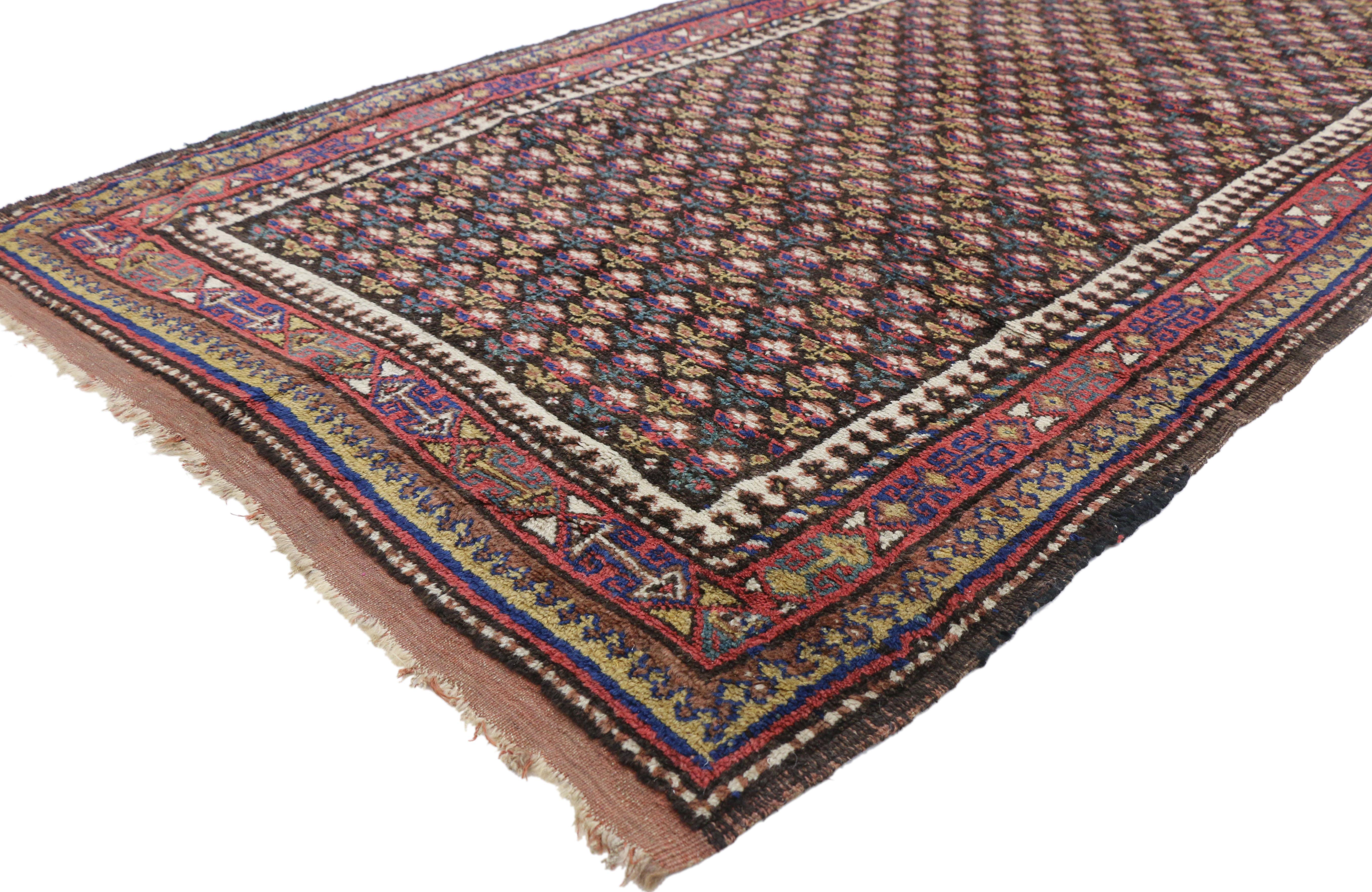 20795, antique Kurdish Persian runner with Victorian cottage style, wide hallway runner. This hand knotted wool antique Kurdish Persian runner features an all-over repeat floral pattern spread across an abrashed coffee field. Offset rows of flowers