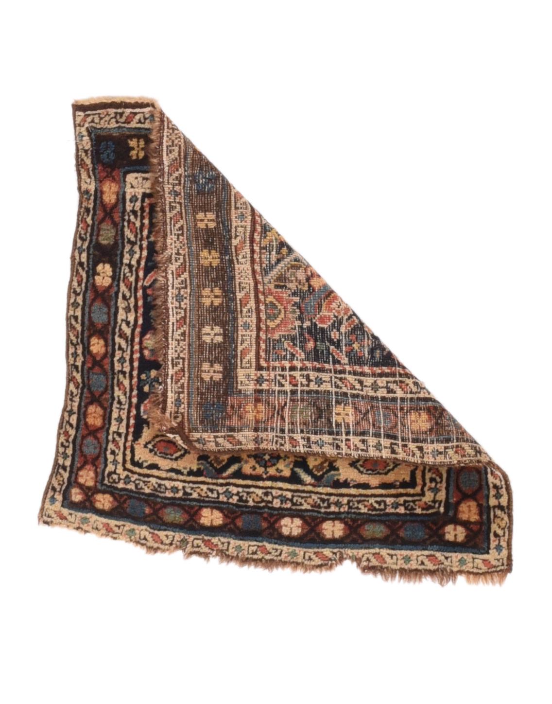 Antique Kurdish Rug 1'9'' x 1'9''. The near black field shows a vertically slipped section of the Herati design, highlighted in straw, green and cream. Abrashed brown border with a rounded quincunx repeat on a linked open hexagon chain. S-chain