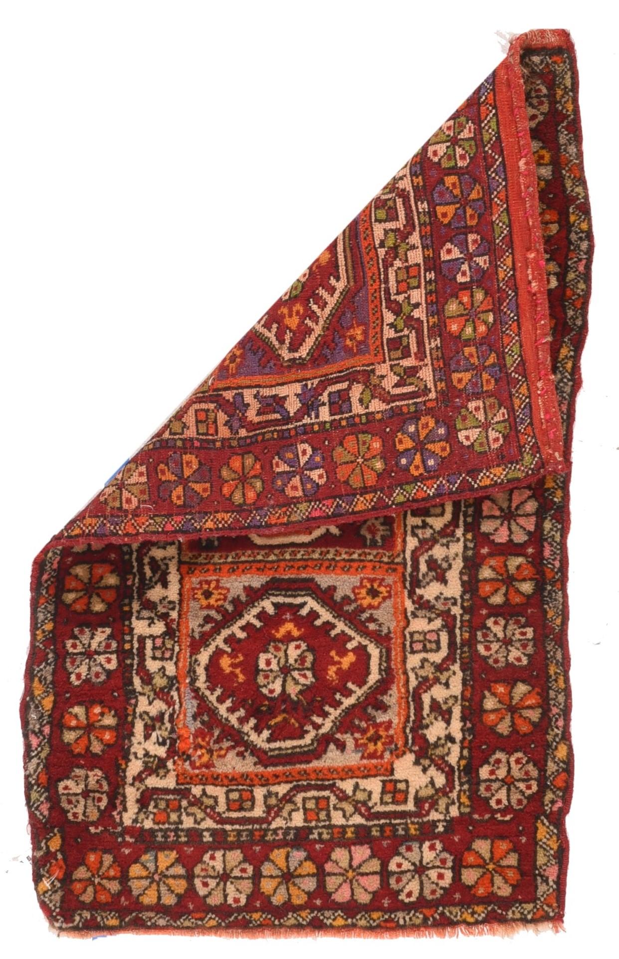 Antique Kurdish rug 1'9'' x 2'11''. Probably Central Anatolian, the tripartite paneled field in mauve and red, contains three nested and fringed hexagons in cream, red and straw, within a main red main border pf pinwheel rosettes and a secondary