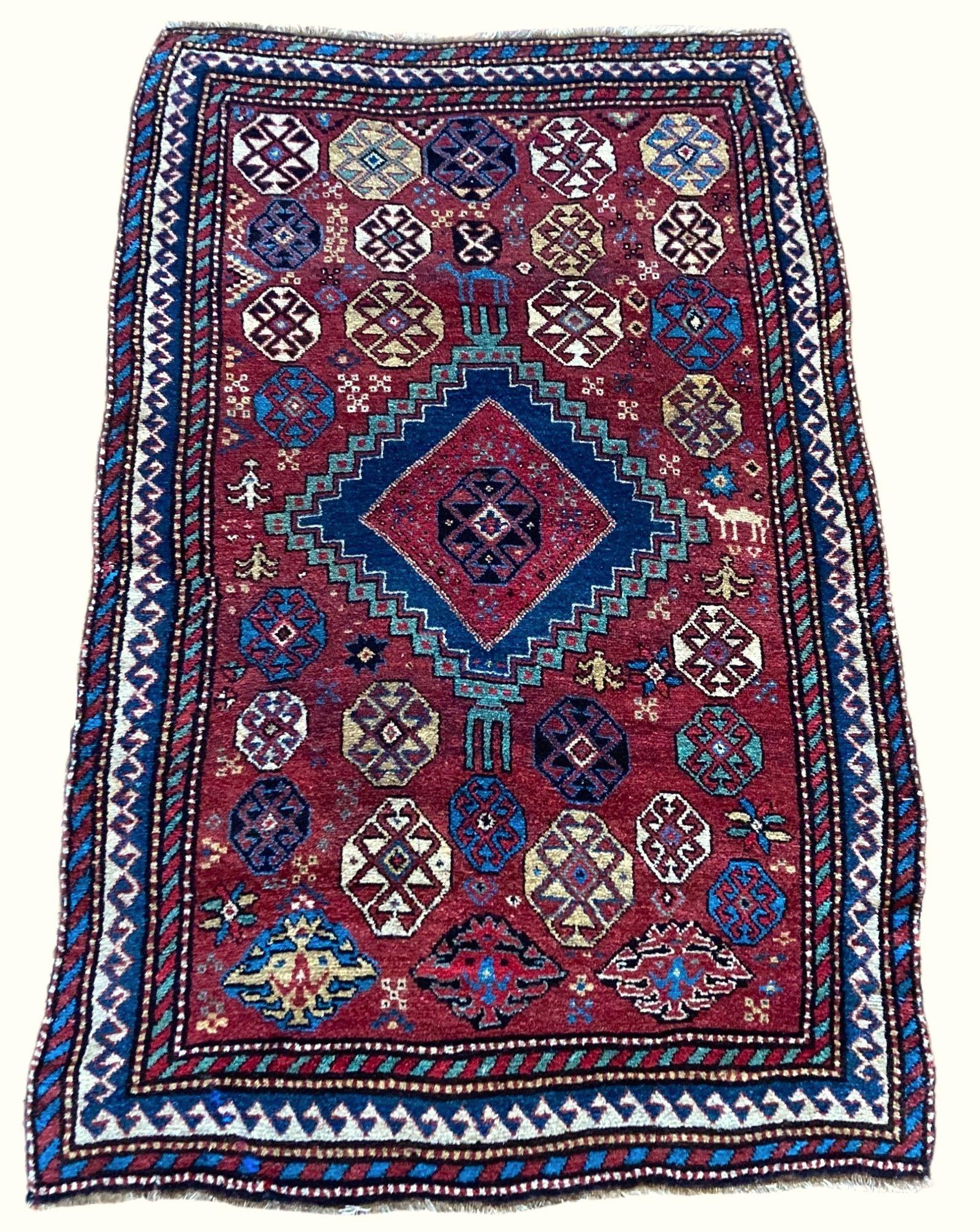 A fabulous antique Kurdish rug, woven circa 1890 with a geometrical medallion on a terracotta field and hook border. There’s so much I love - the quality of the wool, the great dyes and the random design (including a couple of camels!). A great