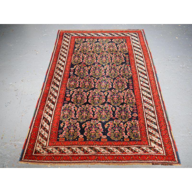 Antique Kurdish rug with all over boteh design on a dark indigo blue field. The border is well a drawn barber pole design and adds interest to the rug.

Aa good Kurdish rug with a dark indigo blue ground covered with large floral boteh drawn in