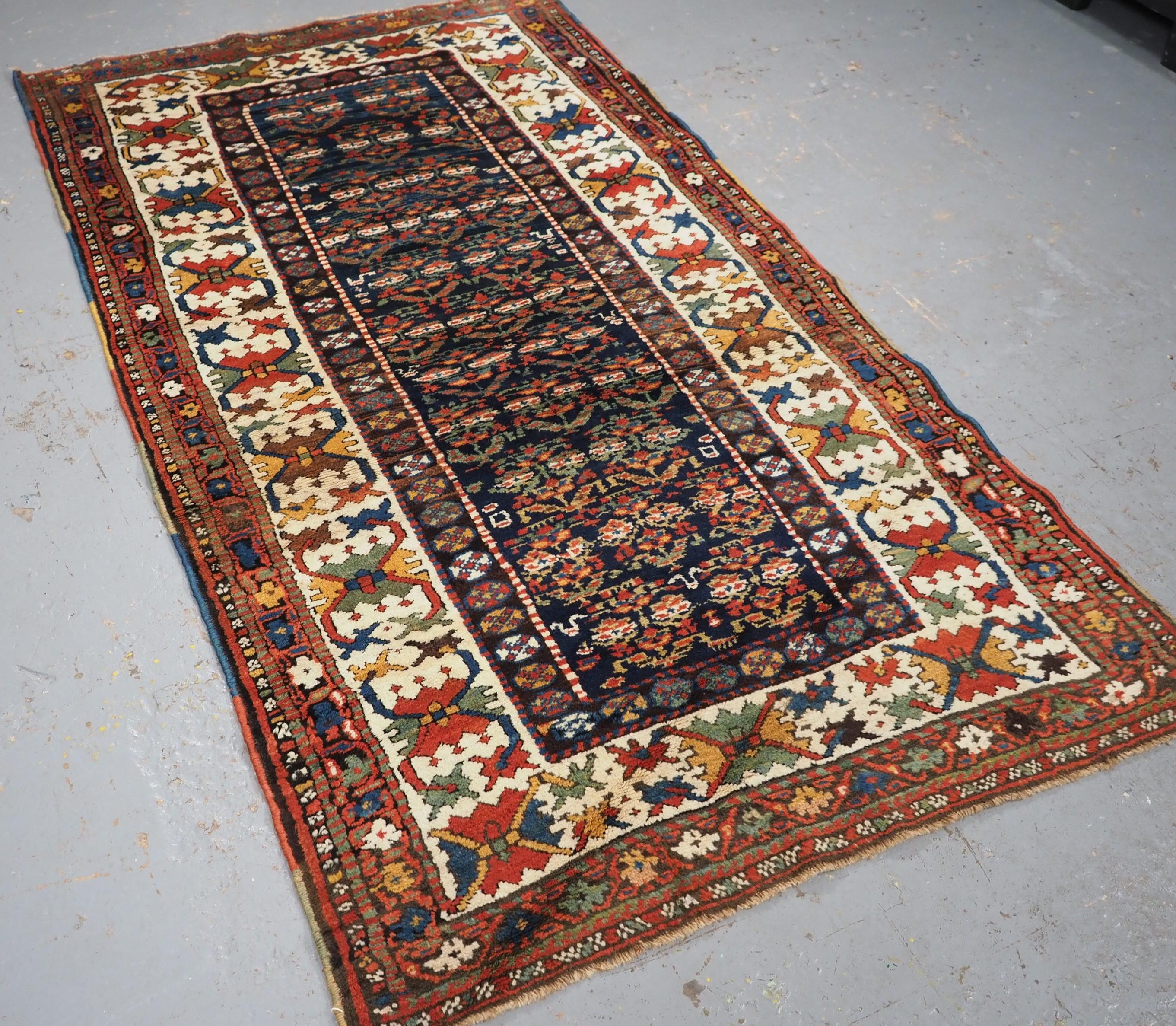 
Size: 7ft 2in x 4ft 0in (219 x 121cm).

Antique Kurdish rug with colourful shrub design.

Circa 1900

This rug is an outstanding example of Kurdish weaving, the colourful shrub design stands out against the midnight blue ground. The wide ivory