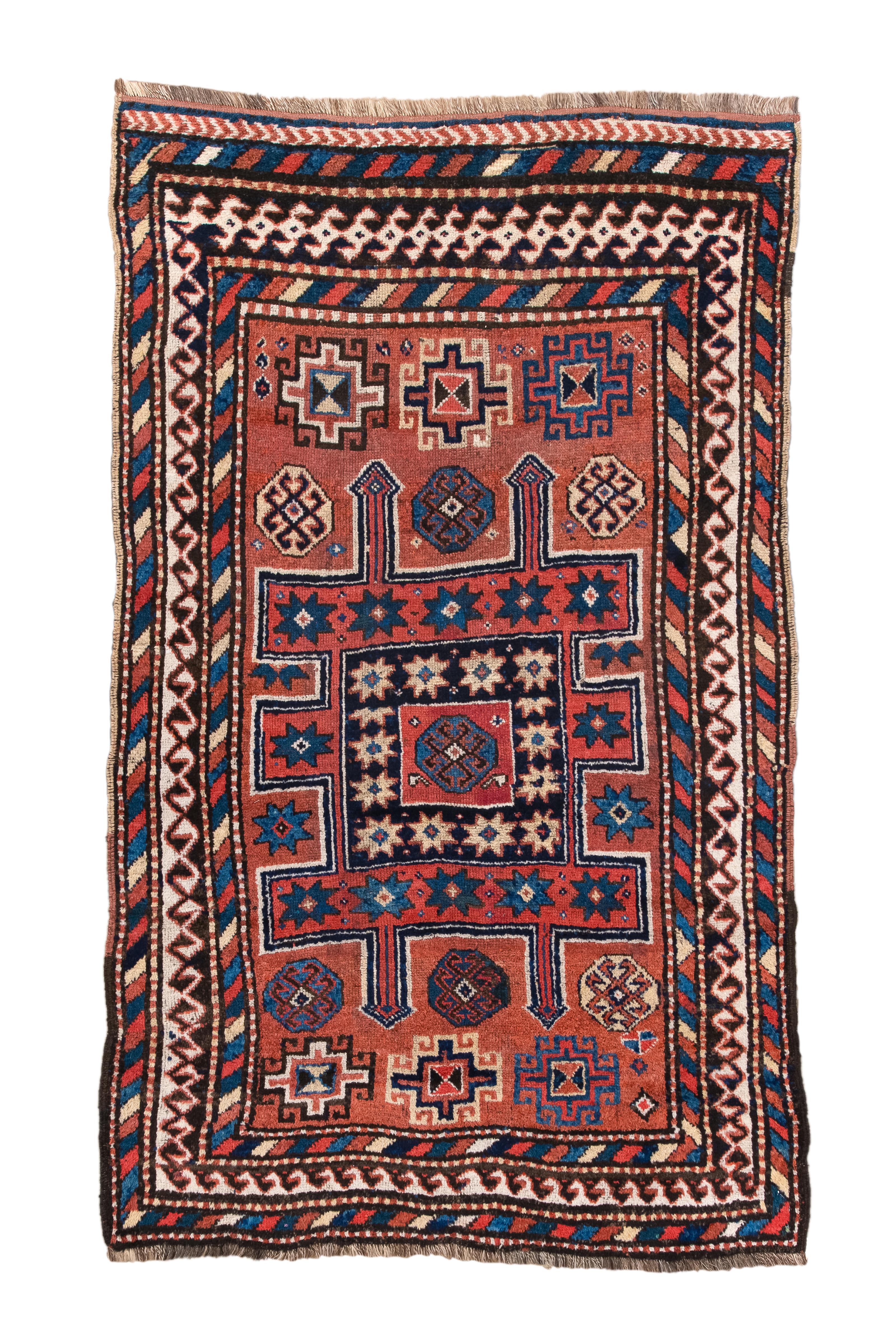 It's truly captivating how this geometric masterpiece comes to life through its subdued shades of red ochre and cola. The Quchan carpet, measuring 4x6'6
