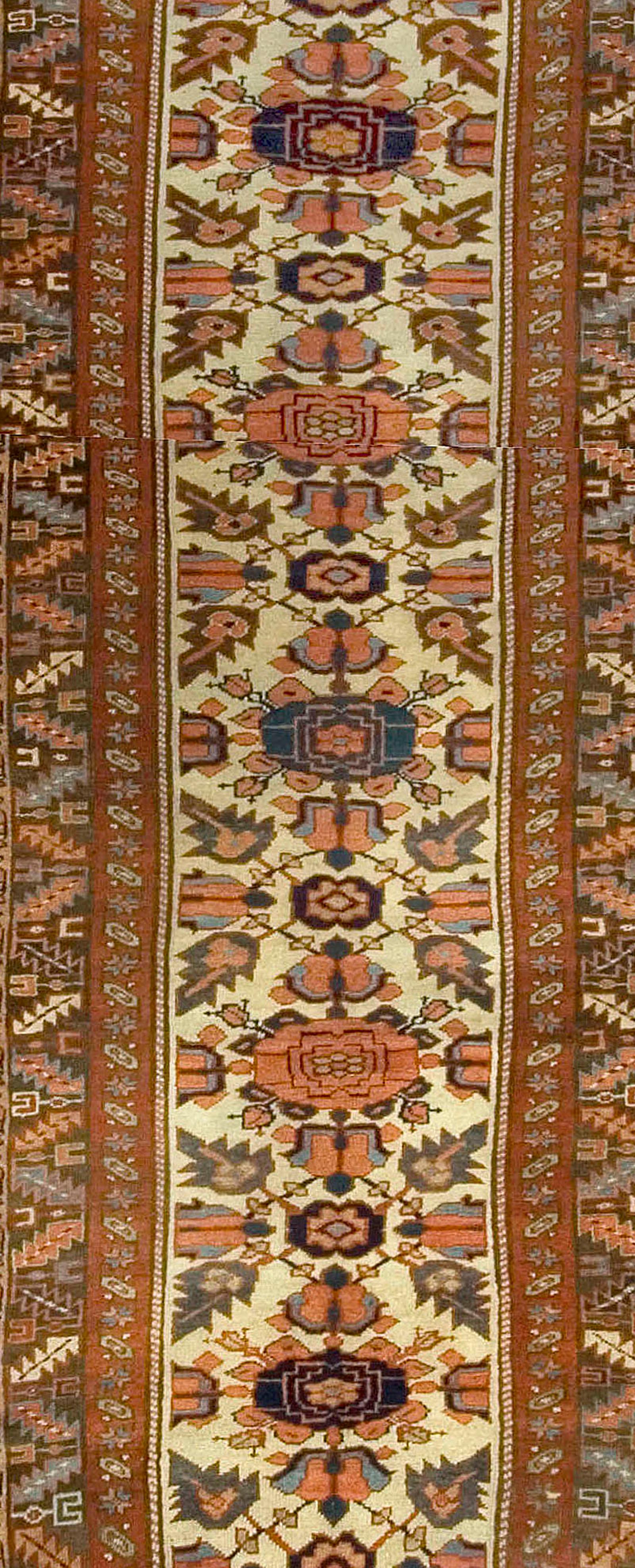 Antique Kurdish runner. A pleasant floral pattern woven in bright colors plays over the ivory central field. A border containing four rows of geometric floral and vine-scroll patterns woven in browns blues violets and reds completes the overall
