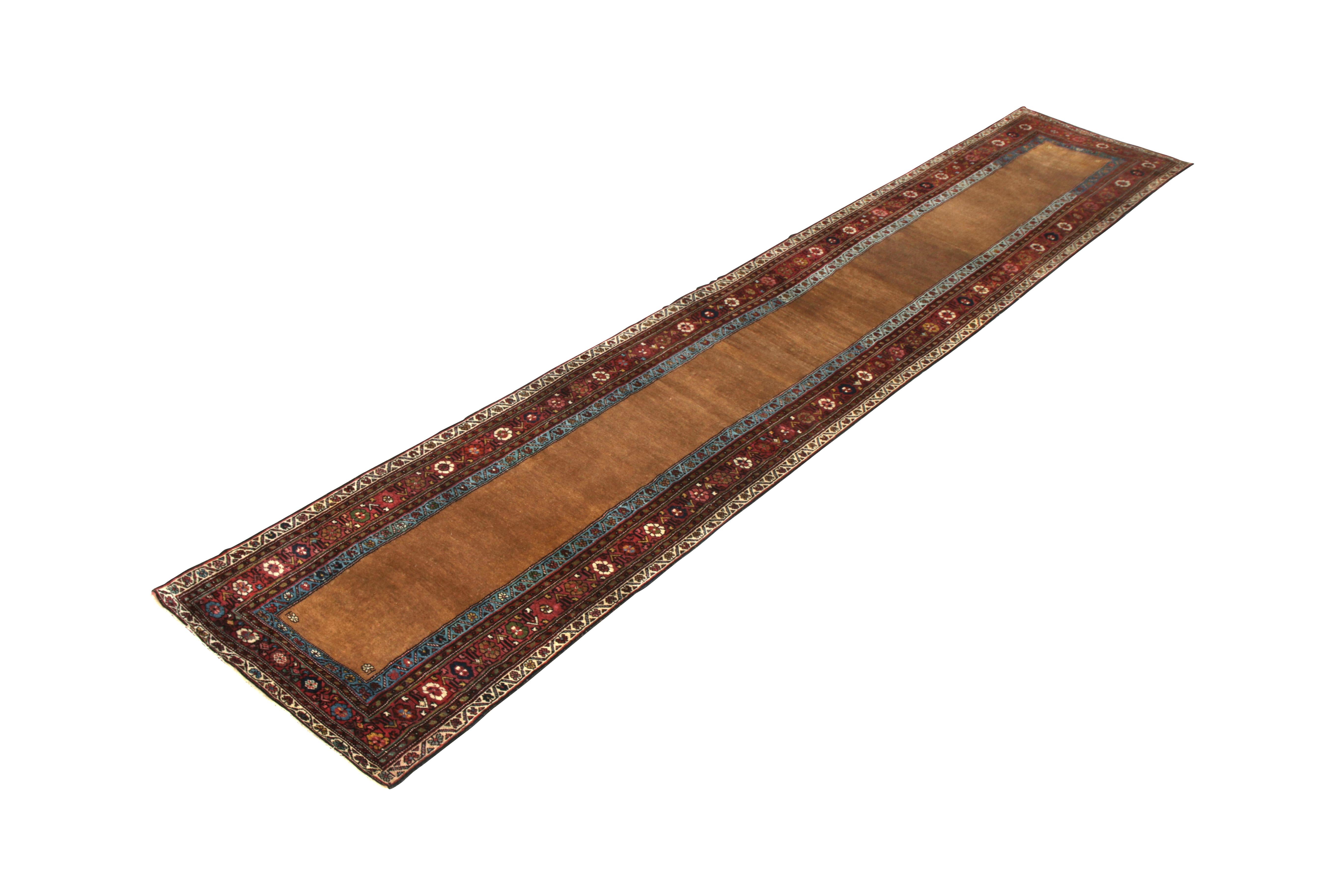 Hand knotted in wool originating circa 1890-1900, this antique Persian runner employs a uniquely refined Kurdish rug design in 3’1 x 15, featuring a graceful floral design in the central border with a notes of green in the guard border complementing