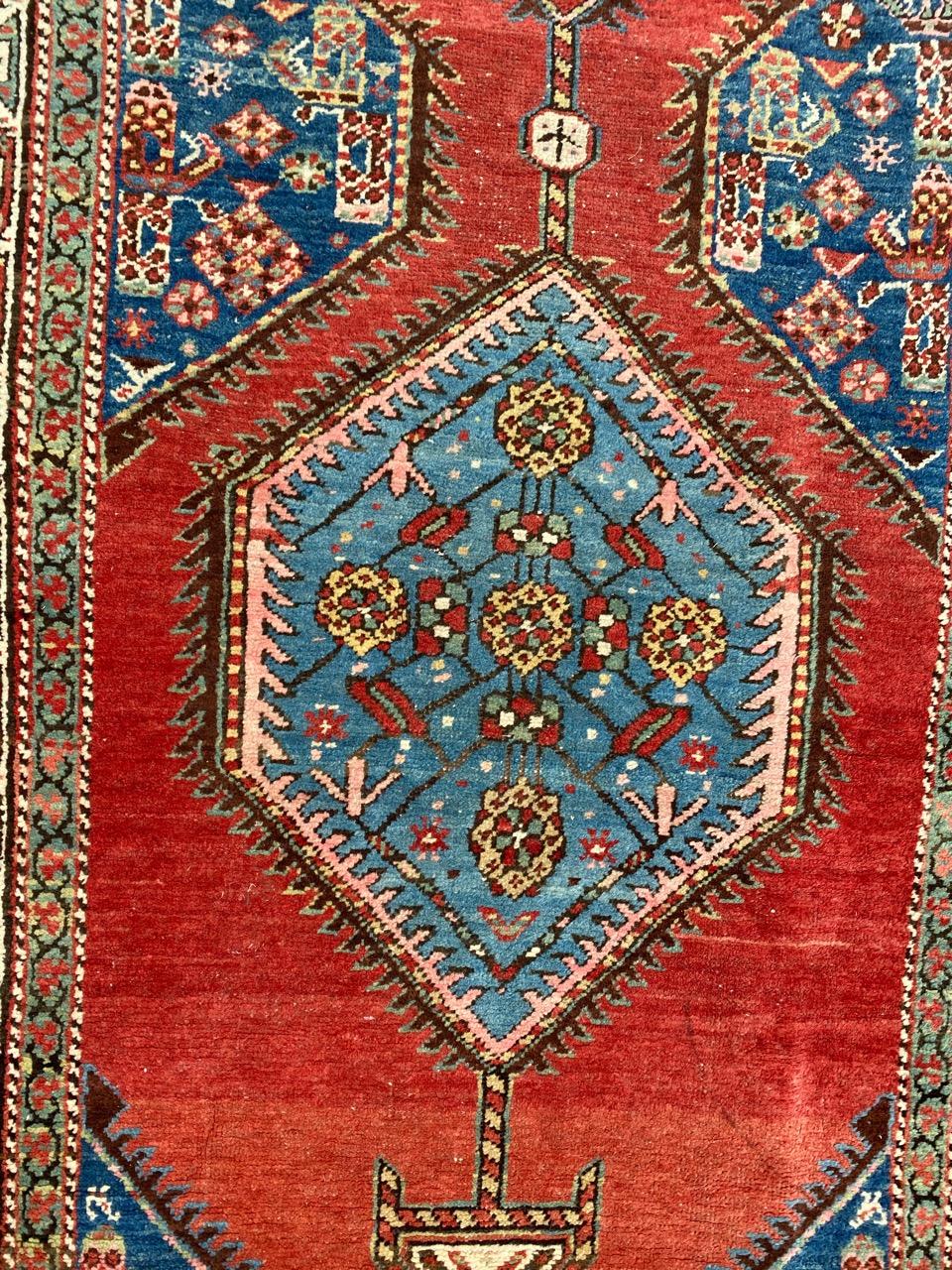 Discover the allure of this exquisite tribal Northwestern runner featuring a stunning geometric design and vibrant natural colors. Meticulously hand-knotted with wool velvet on a cotton foundation, this masterpiece showcases a vivid red field