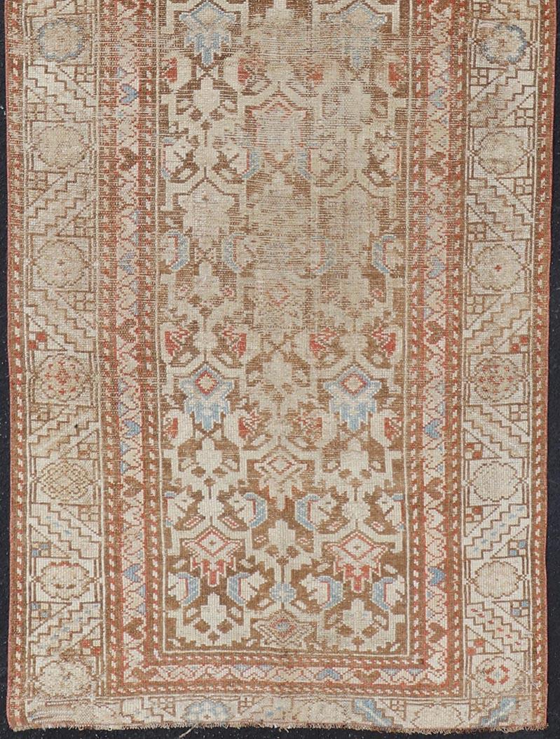 Antique Kurdish runner in soft tones in wool with all-over tribal design.
Rug/R20-0708, country of origin / type: Iran / Kurdish, circa 1900.
Measures: 3'0 x 8'1.
This antique Persian Kurdish runner has been hand-knotted in wool and features an
