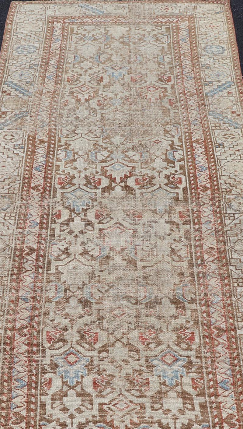 Persian Antique Kurdish Runner in Soft Tones in Wool with All-Over Tribal Design For Sale