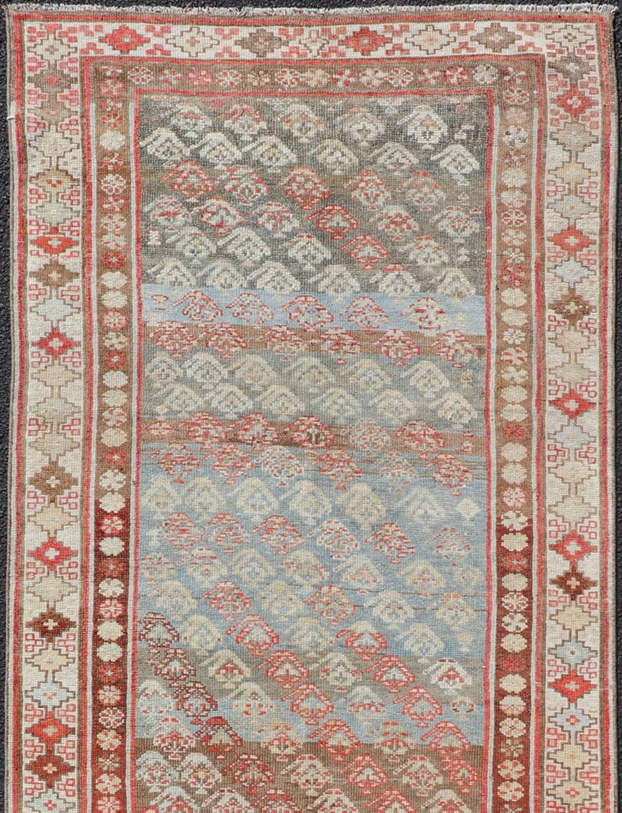 Measures:3'5 x 10'3.
Antique Kurdish Runner in soft tones in Wool with Sub-Geometric Paisley Design. Keivan Woven Arts / rug EMB-9682-P13585, country of origin / type: Iran / kurdish, circa 1900.

This antique Persian Kurdish runner has been