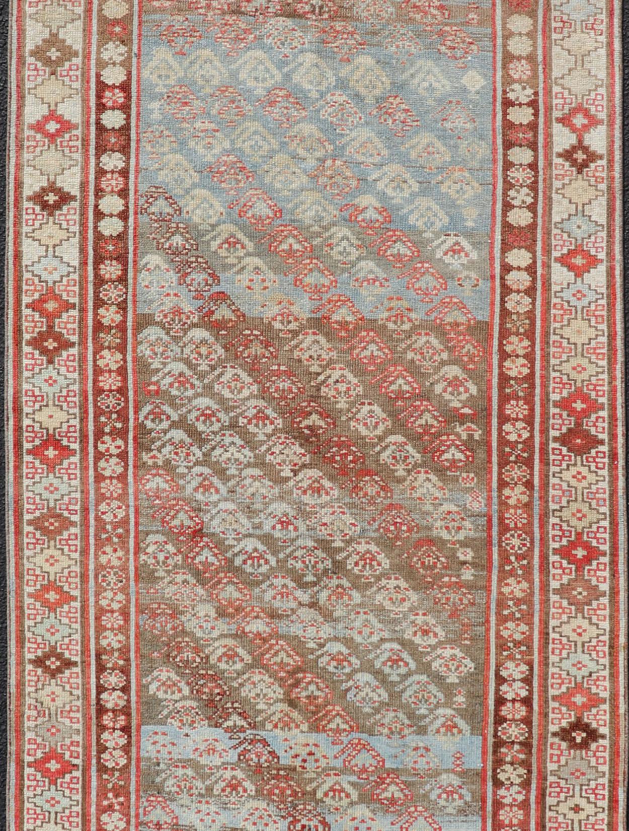 Tribal Antique Kurdish Runner in Soft Tones in Wool with Sub-Geometric Paisley Design For Sale