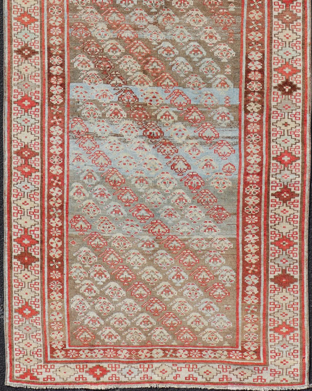 Persian Antique Kurdish Runner in Soft Tones in Wool with Sub-Geometric Paisley Design For Sale