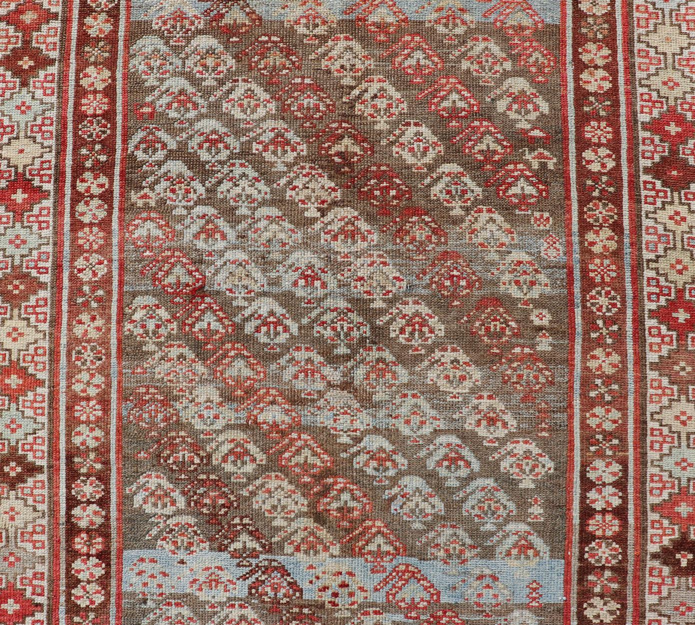 20th Century Antique Kurdish Runner in Soft Tones in Wool with Sub-Geometric Paisley Design For Sale