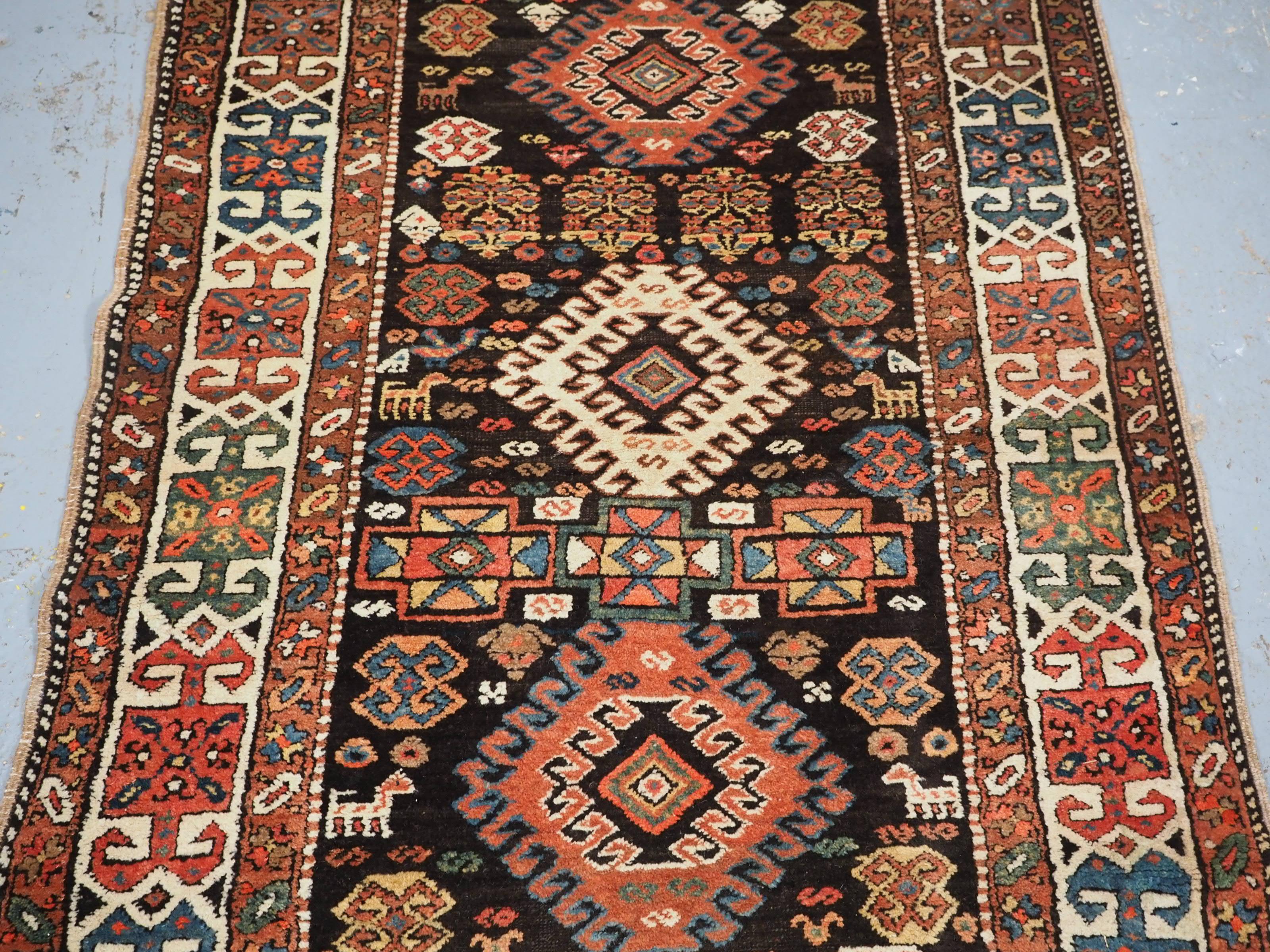 Antique Kurdish runner with latch hook medallion design.  Circa 1890. In Good Condition For Sale In Moreton-In-Marsh, GB