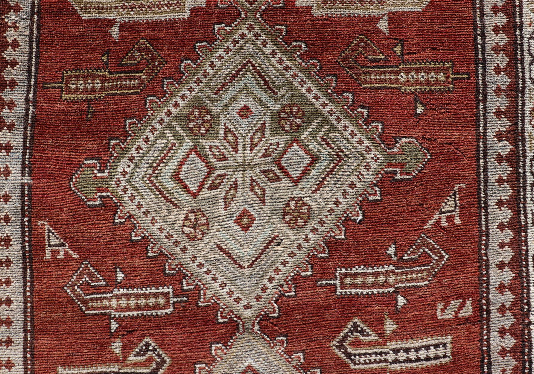 Antique Kurdish Runner with Rusty Red Background and Medallions Tribal Motifs For Sale 1