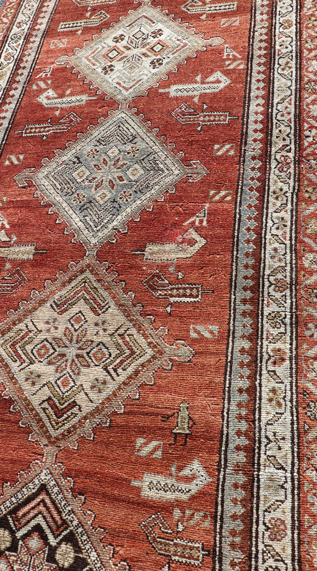 Hand-Knotted Antique Kurdish Runner with Rusty Red Background and Medallions Tribal Motifs For Sale