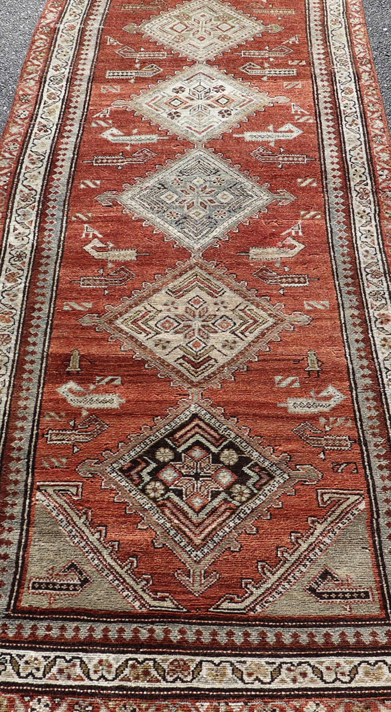 Antique Kurdish Runner with Rusty Red Background and Medallions Tribal Motifs In Good Condition For Sale In Atlanta, GA