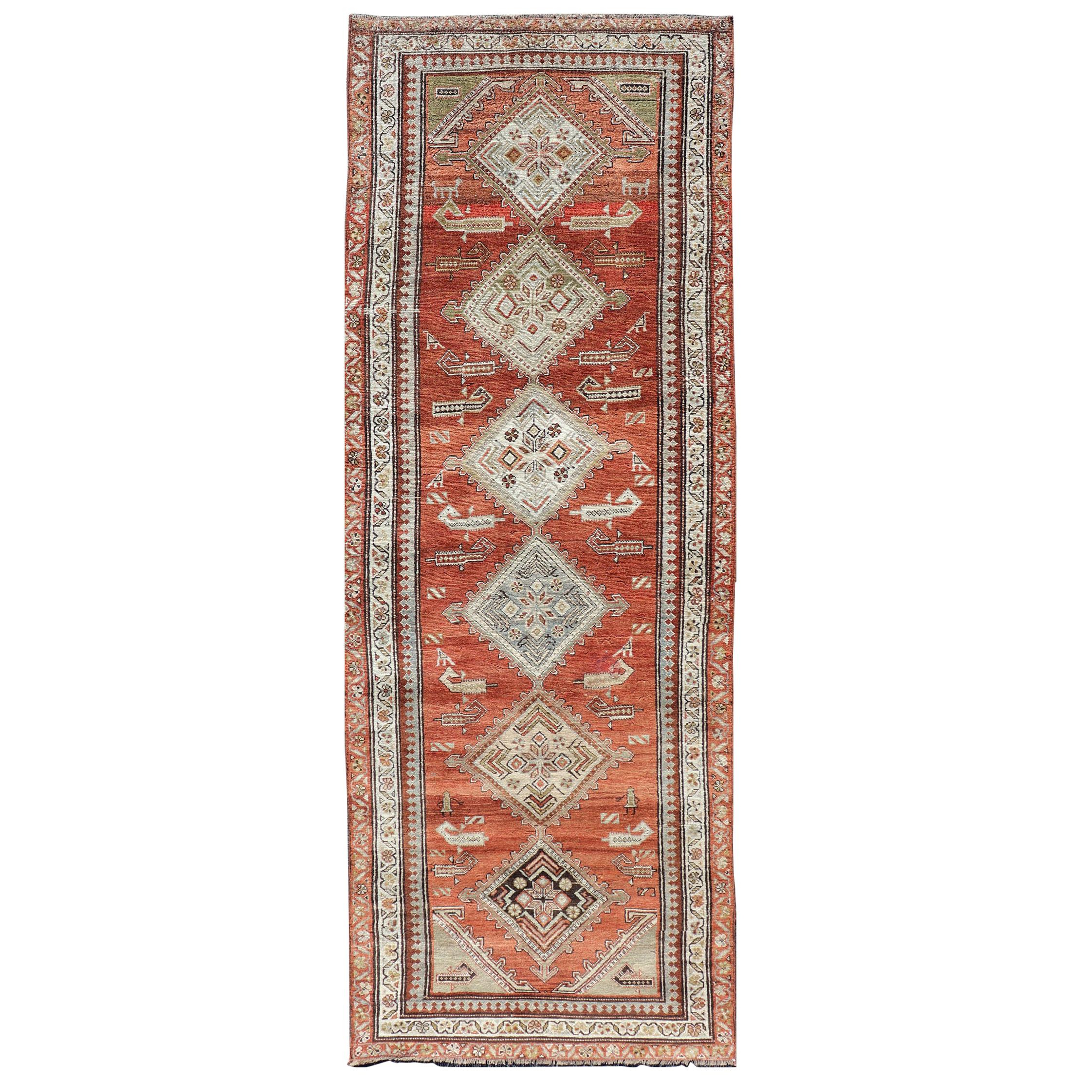 Antique Kurdish Runner with Rusty Red Background and Medallions Tribal Motifs For Sale