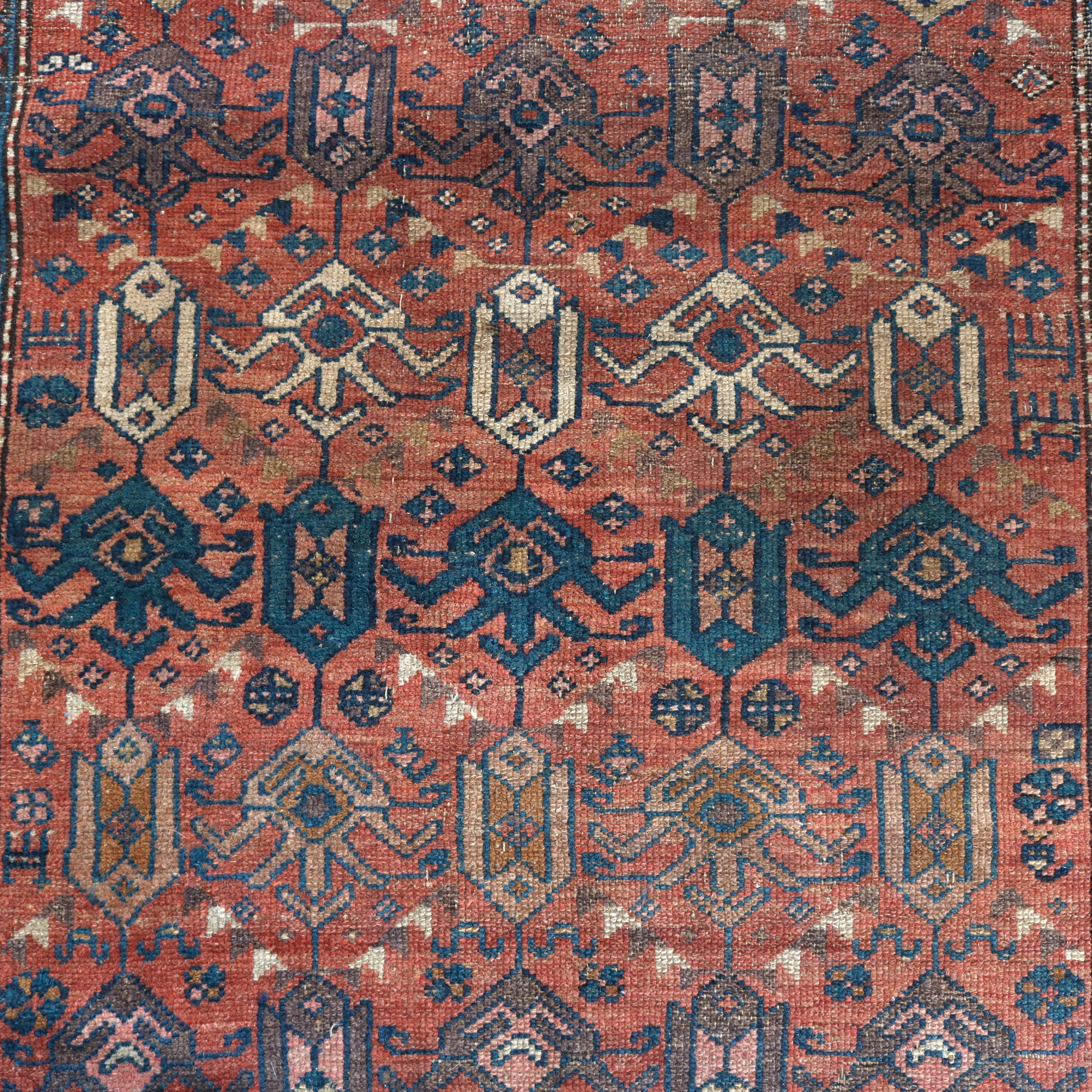 An antique Kurdish tribal oriental rug offers wool construction with all-over stylized design, circa 1920

Measures: 79