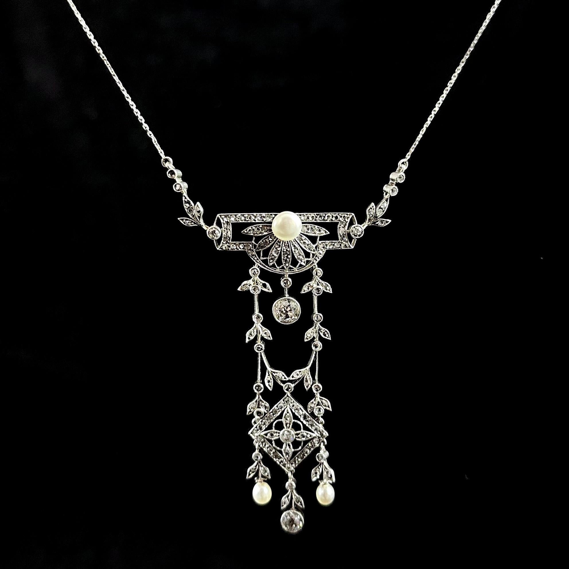 Antique La Belle Époque natural pearl and diamond pendant necklace in platinum and gold, Portuguese, circa 1900. This garland jewel of geometric, floral and foliate motifs is millegrain-set throughout with natural pearls and Old European
