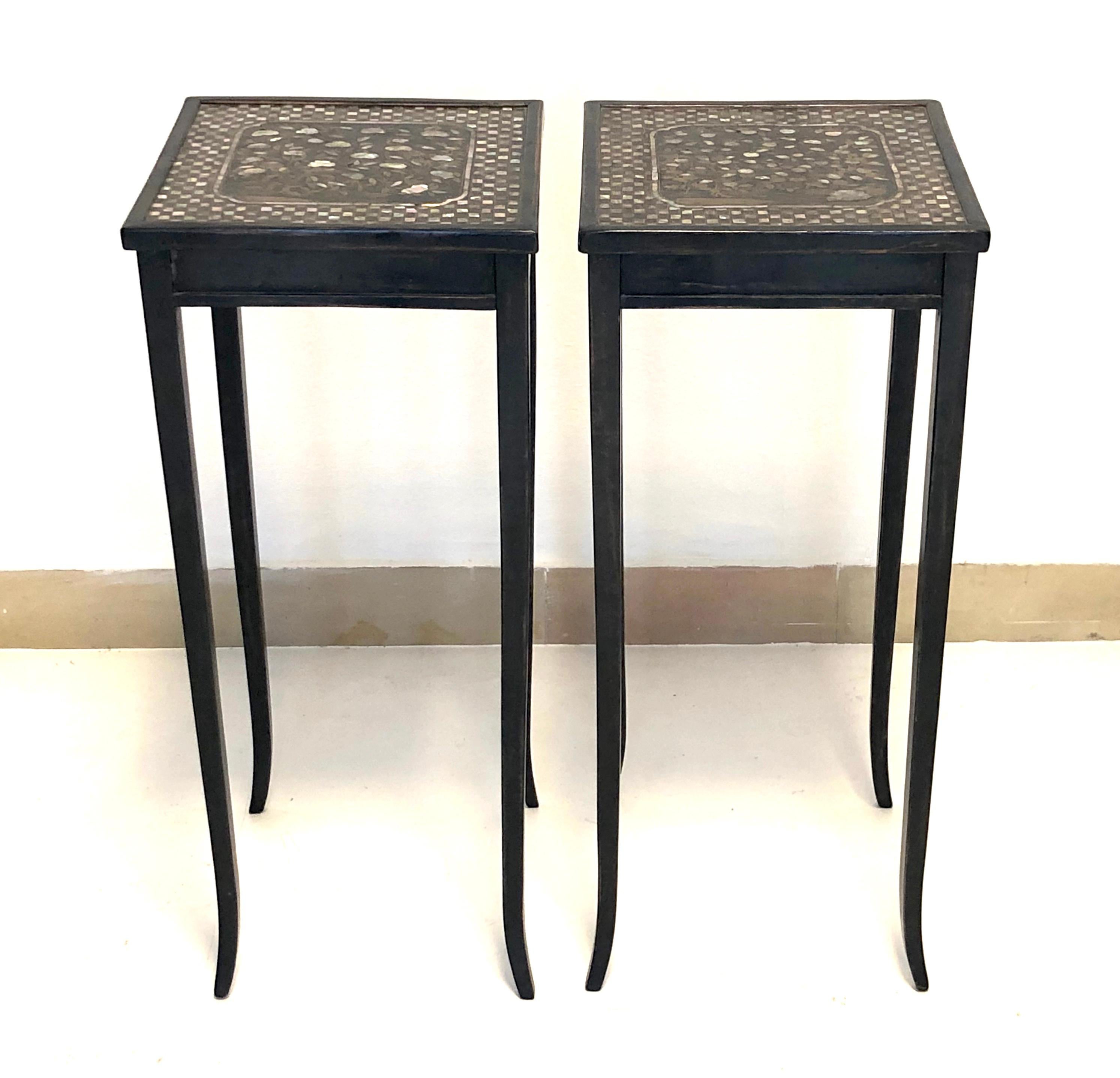 Extremely rare small pair of 19th century black lacquer tables with rare 17th century table tops. The table tops are decorated with mother of pearl inlay and date from the Momoyama period of 17th century Japan. The chequer board outer edge surrounds