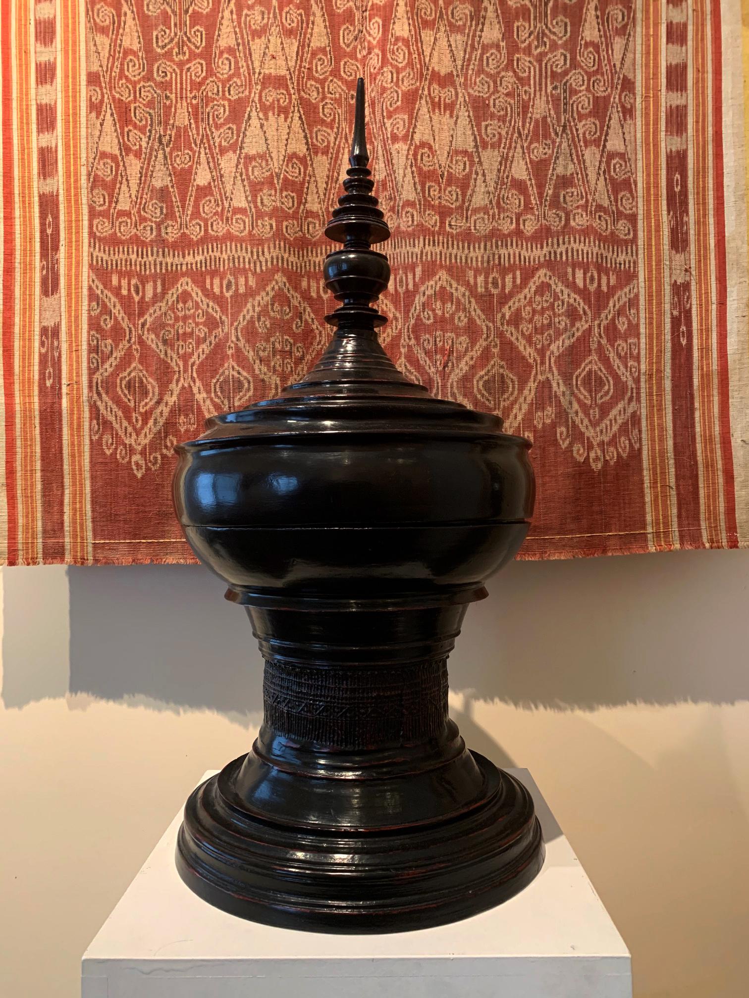 A Southeast Asian lacquer vessel of iconic form from Burma or Norther Thailand, circa turn of the 20th century. This covered vessel is called a “Hsun Ok” and was made in the form of the large stupa of the Buddhist temple. They are owned used for