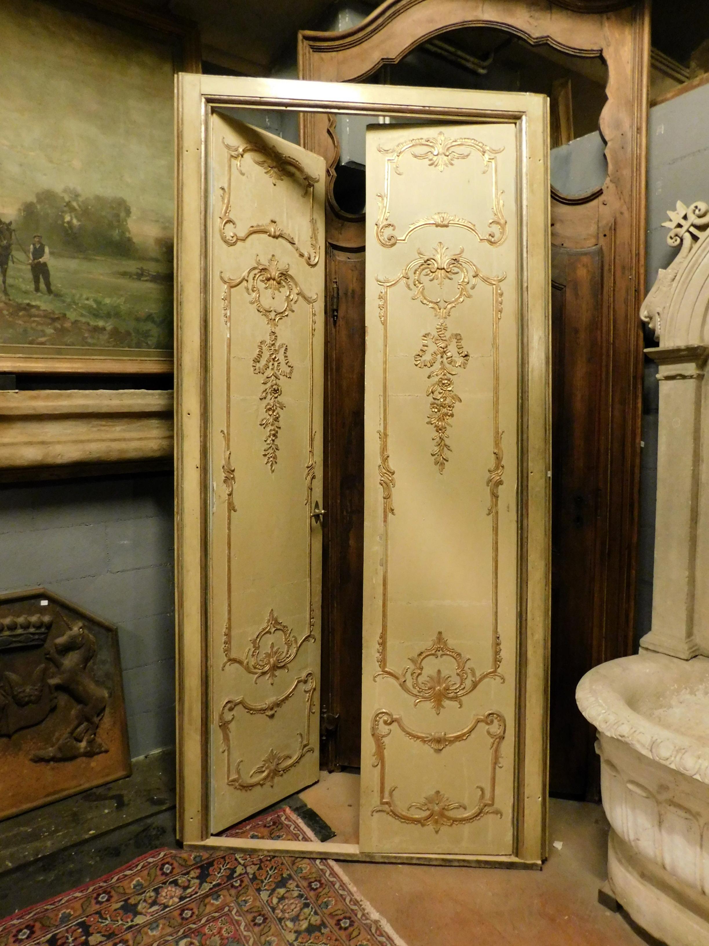 Ancient double-wing door, complete with original non-bulky frame, with rich and golden motifs carved molure, completely hand-built in the 19th century, from Milan, is also painted and finished on the back, original brass handle in good condition