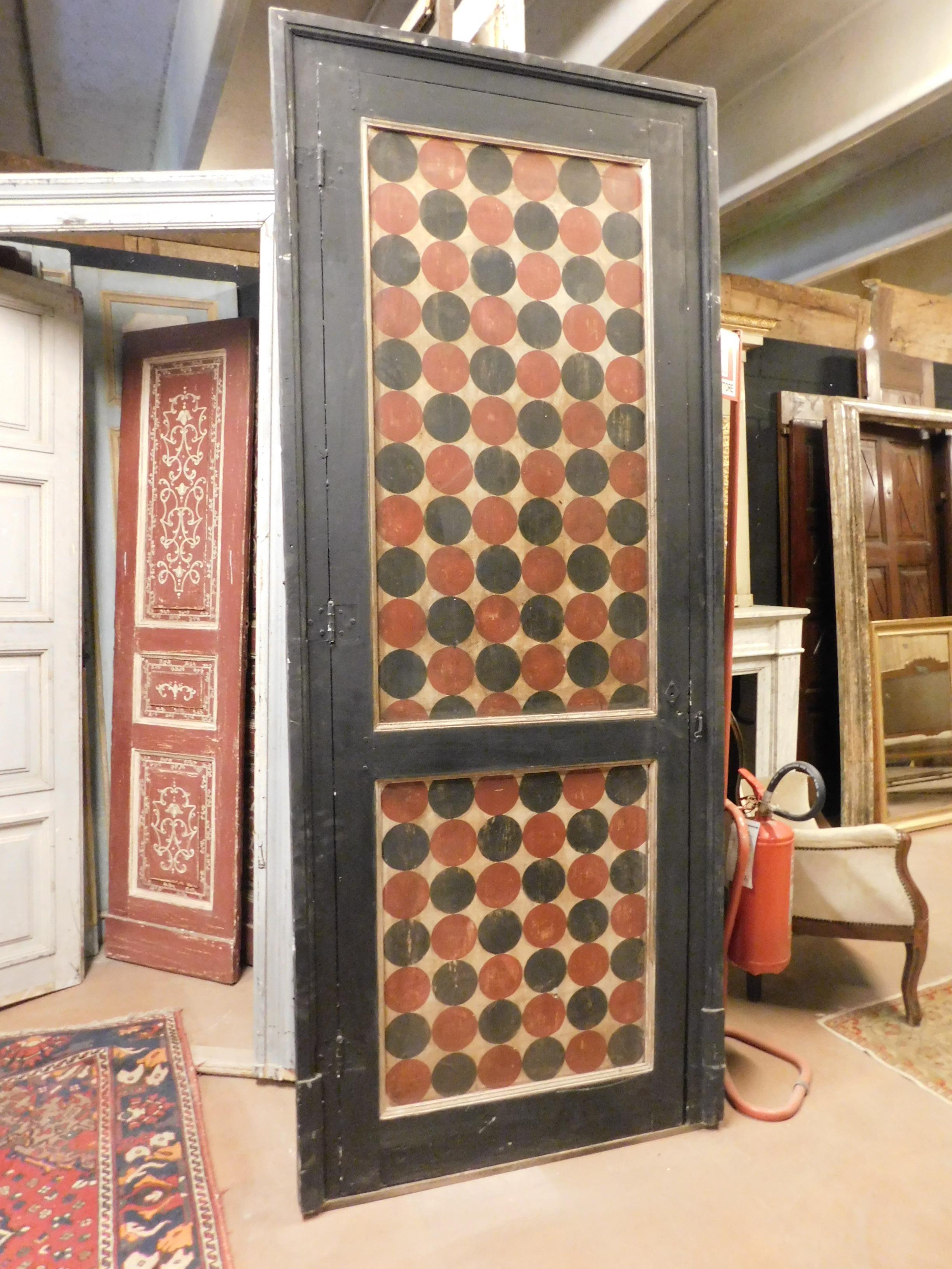 Antique lacquered and painted door complete with frame, with red and black dots texture, colors taken from the upholstery of the time that furnished the house in which it was, built by hand and painted in the twentieth century, for a house in Italy