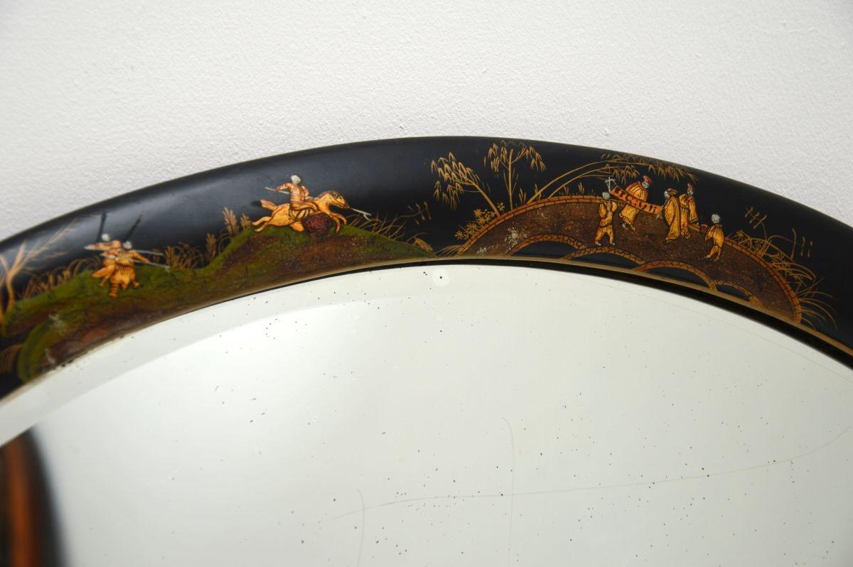 A beautiful antique lacquered chinoiserie mirror. This was made in England, it dates from around the 1920’s.

It is a lovely size and has an oval design with gorgeous decorations. The lacquered chinoiserie runs around the whole frame, and the mirror