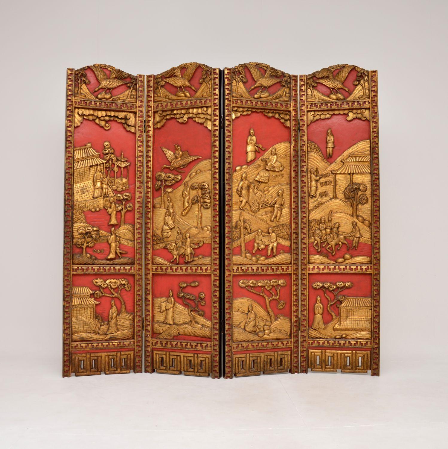 A stunning antique lacquered & gilt oriental folding screen / room divider in carved lacquered & gilded wood. This was made in East Asia, possibly China or Japan, it dates from the early 20th century around 1900-1920, or possibly a bit earlier.

It