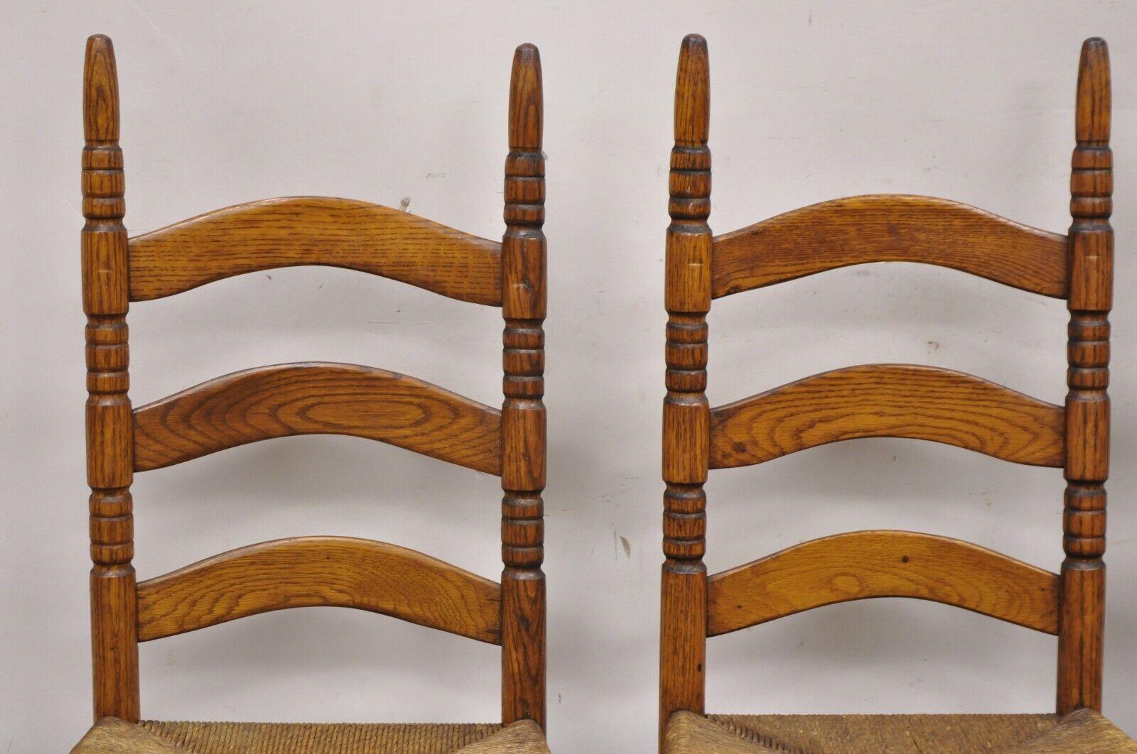 Antique Ladderback Primitive Rustic Oak Wood Rush Seat Dining Chairs - Set of 4. Item featured is a nice smaller size, turn carved pointed finials, woven rope cord 