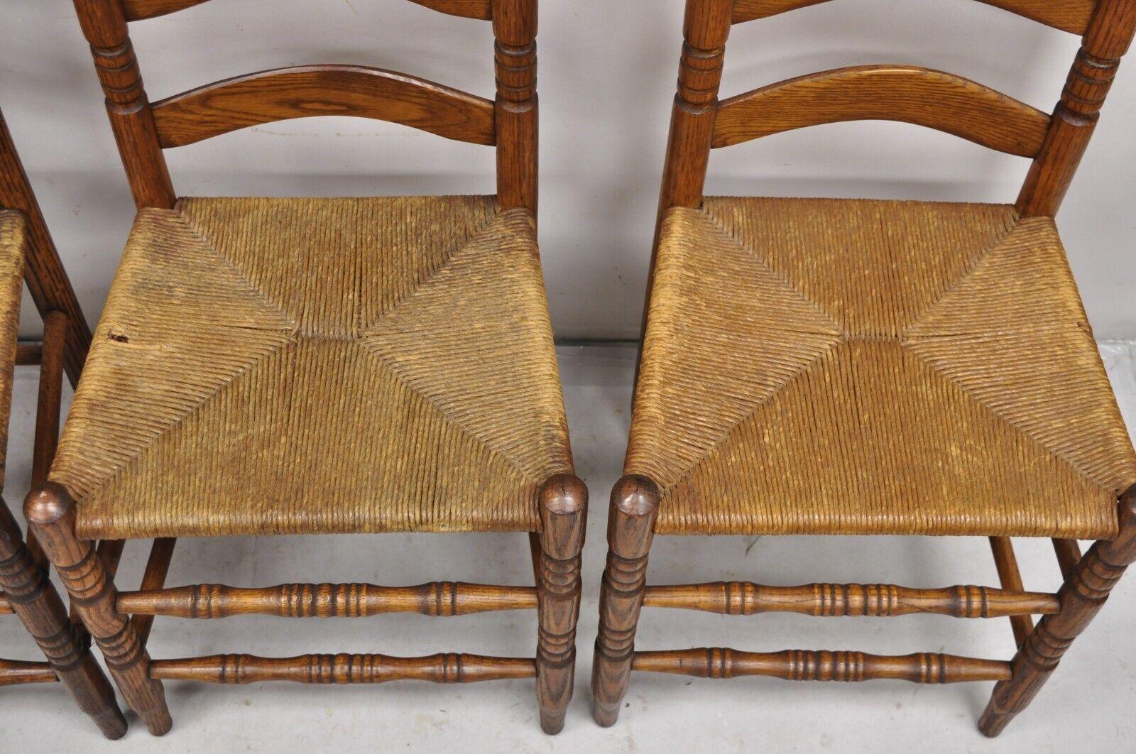 Early 20th Century Antique Ladderback Primitive Rustic Oak Wood Rush Seat Dining Chairs - Set of 4 For Sale